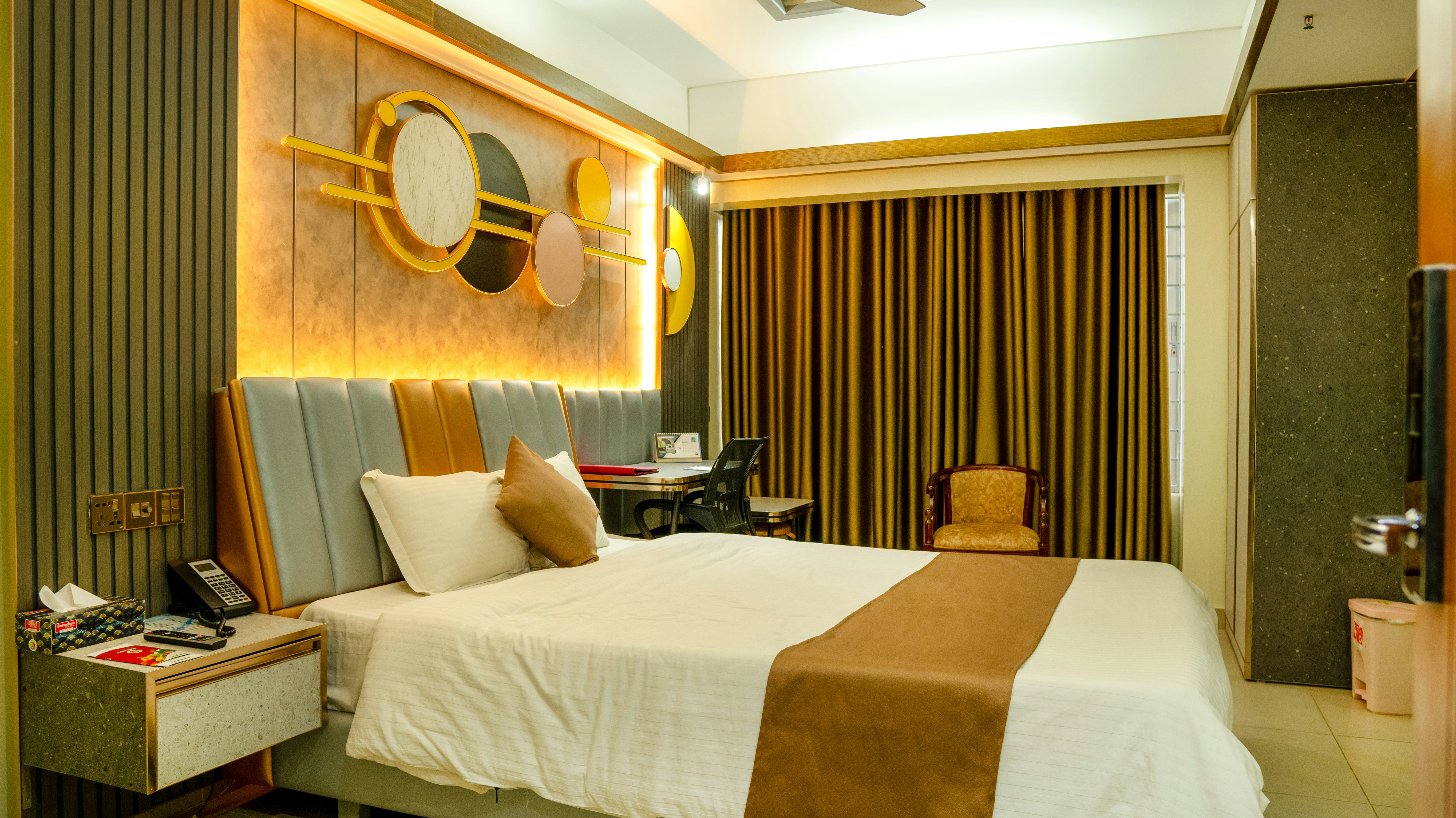 Serene boutique hotel bedroom with warm lighting at Tradewinds Carmel