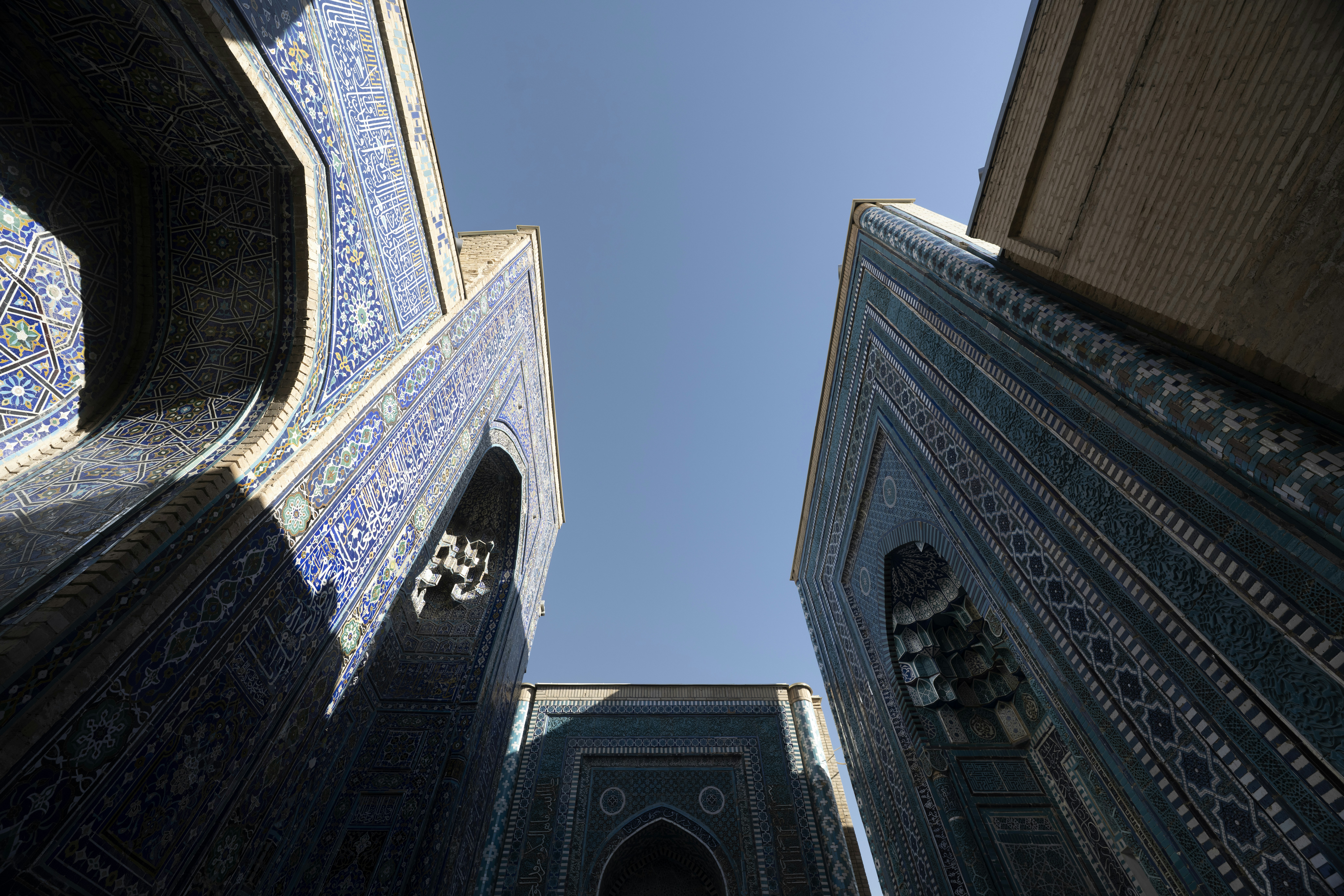 Low angle view of blue tiled archways at the Shah-i-Zinda necropolis in Samarkand
