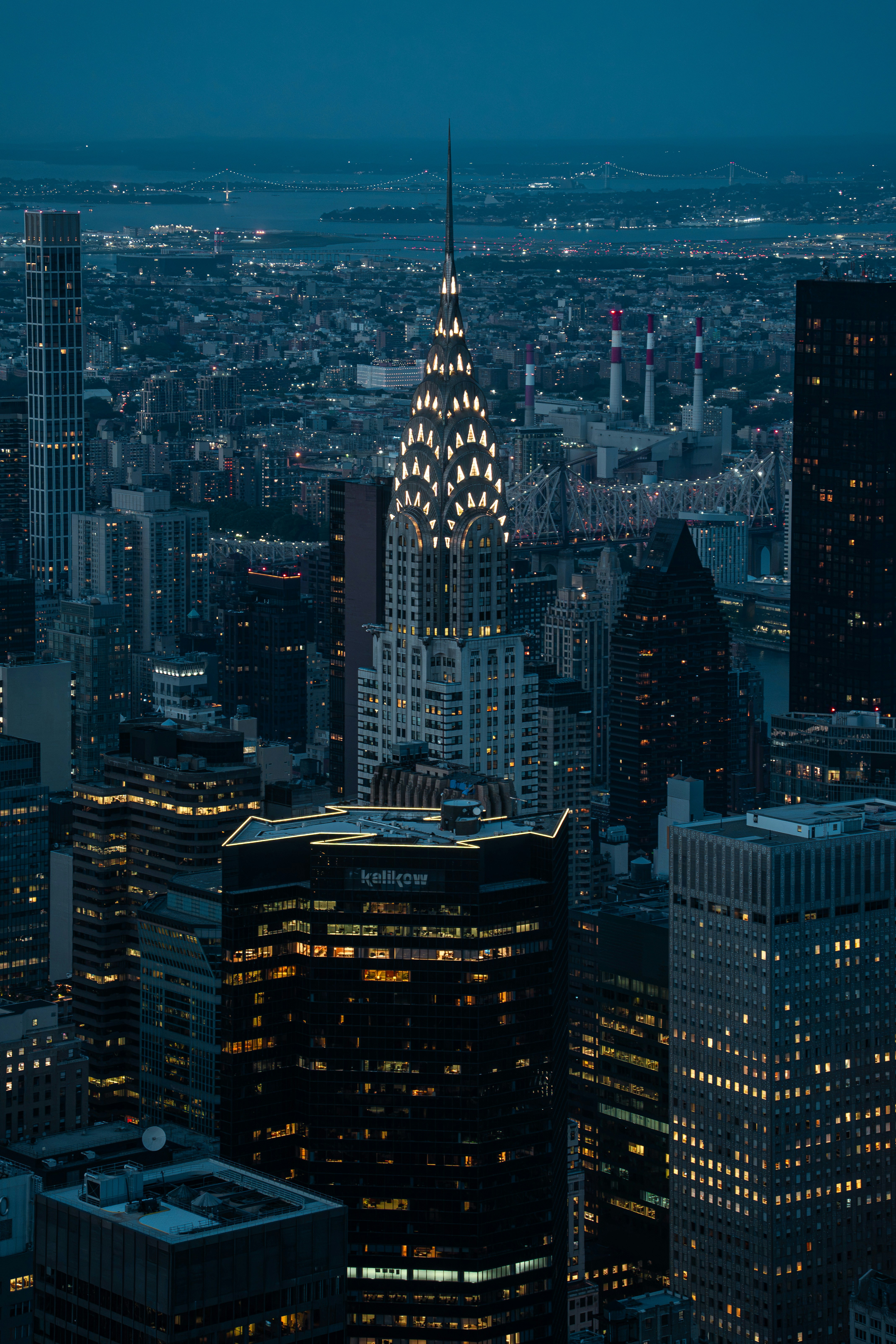 The Chrysler Building illuminated at night among the skyscrapers of New York City