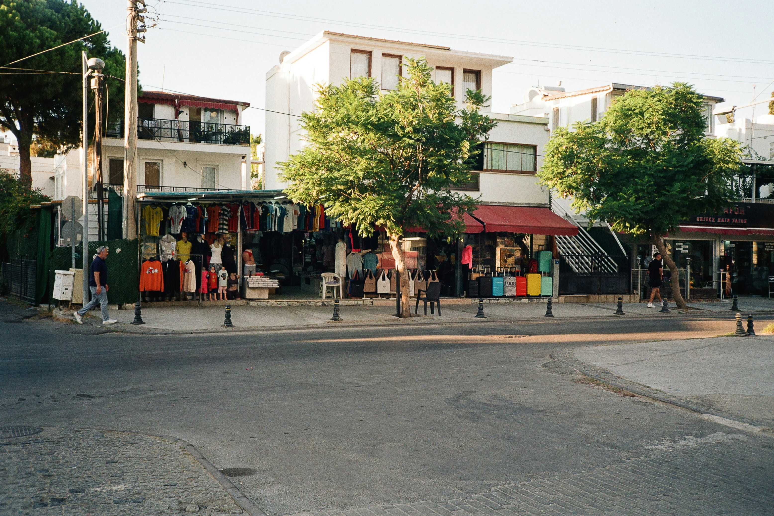 A street corner with clothing shops and luggage in Bodrum, Türkiye