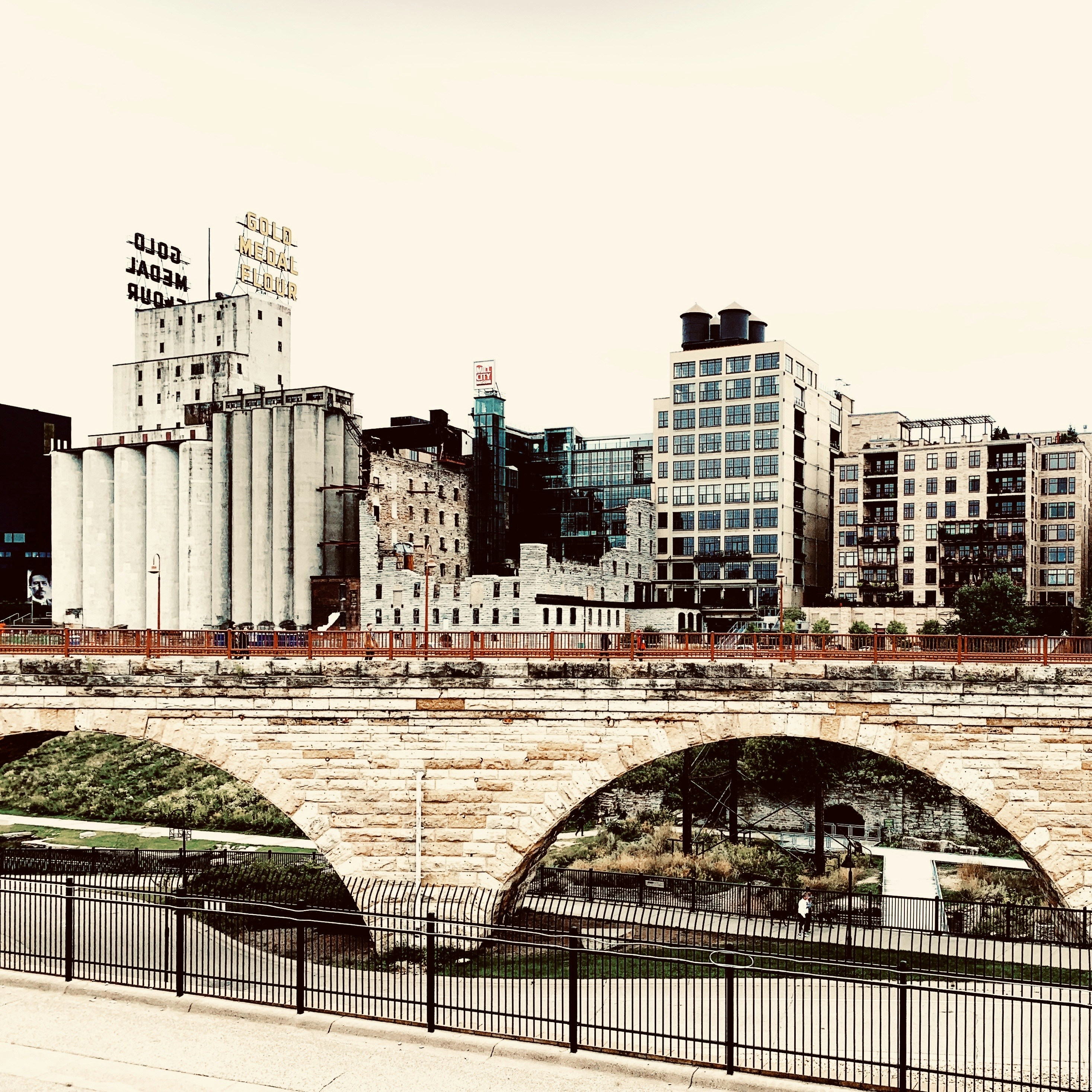 Stone arch bridge in front of the historic Gold Medal Flour mill in Minneapolis