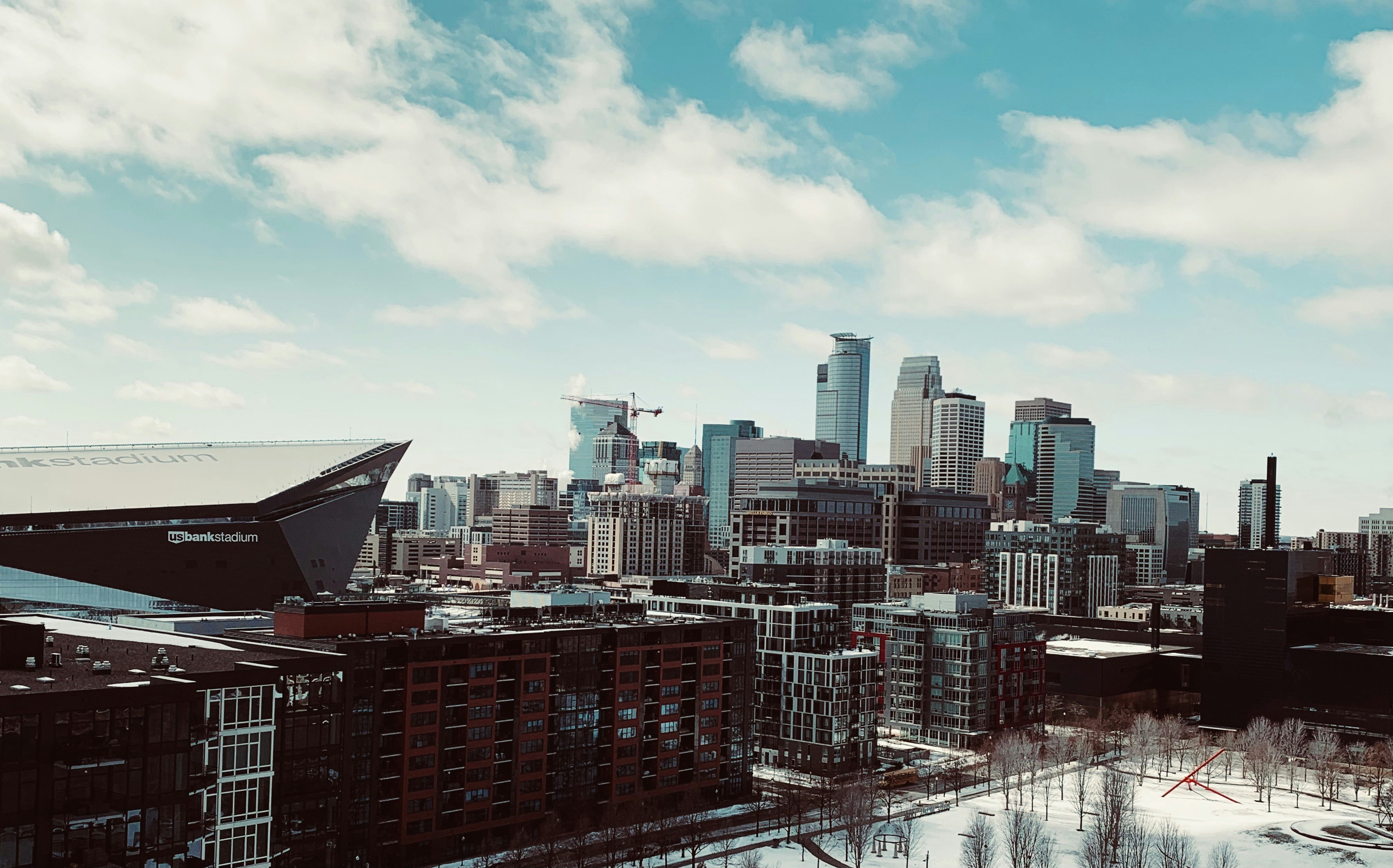 U.S. Bank Stadium and the Minneapolis skyline under a bright blue sky