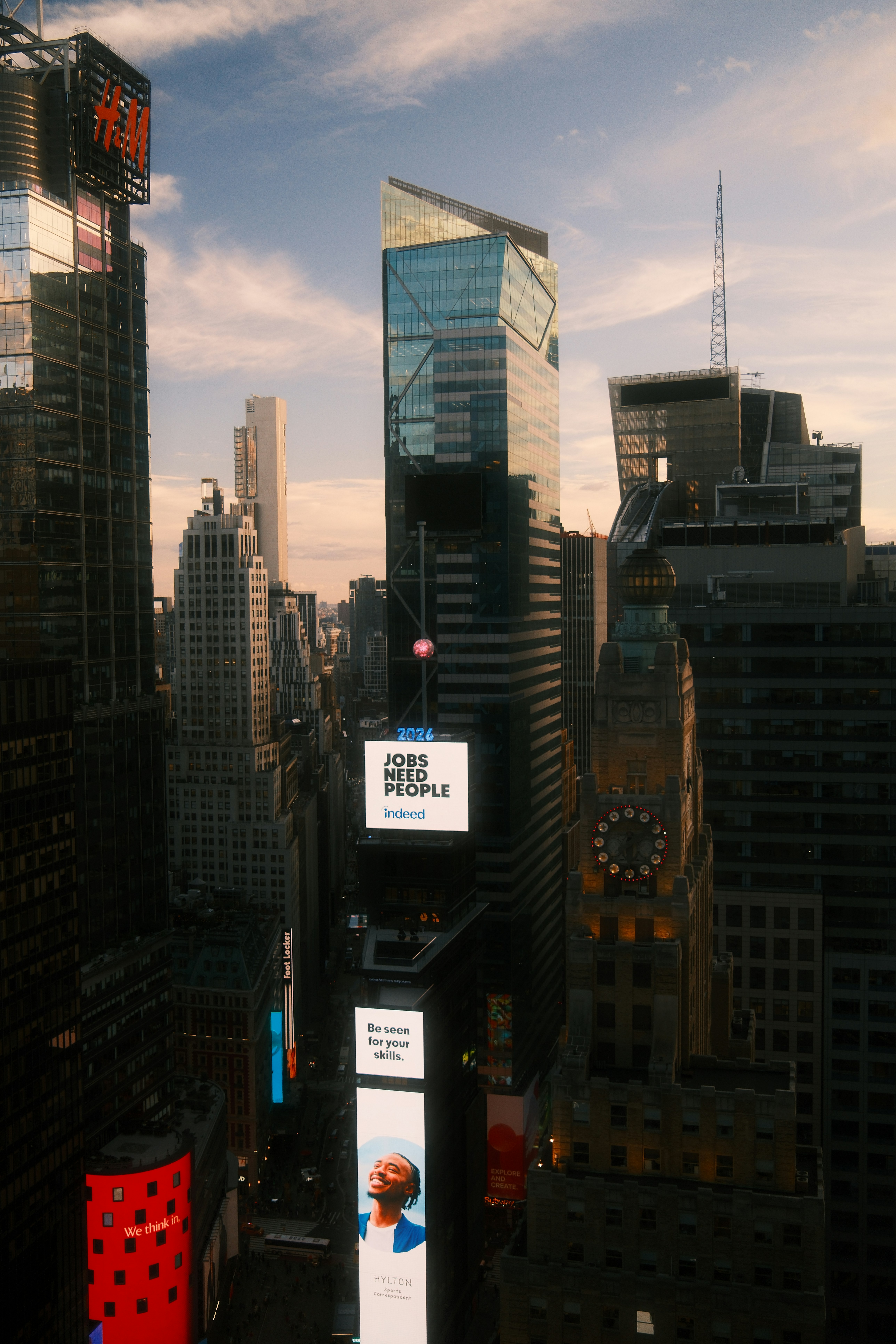 Skyscrapers in Times Square with illuminated digital billboards at golden hour in New York