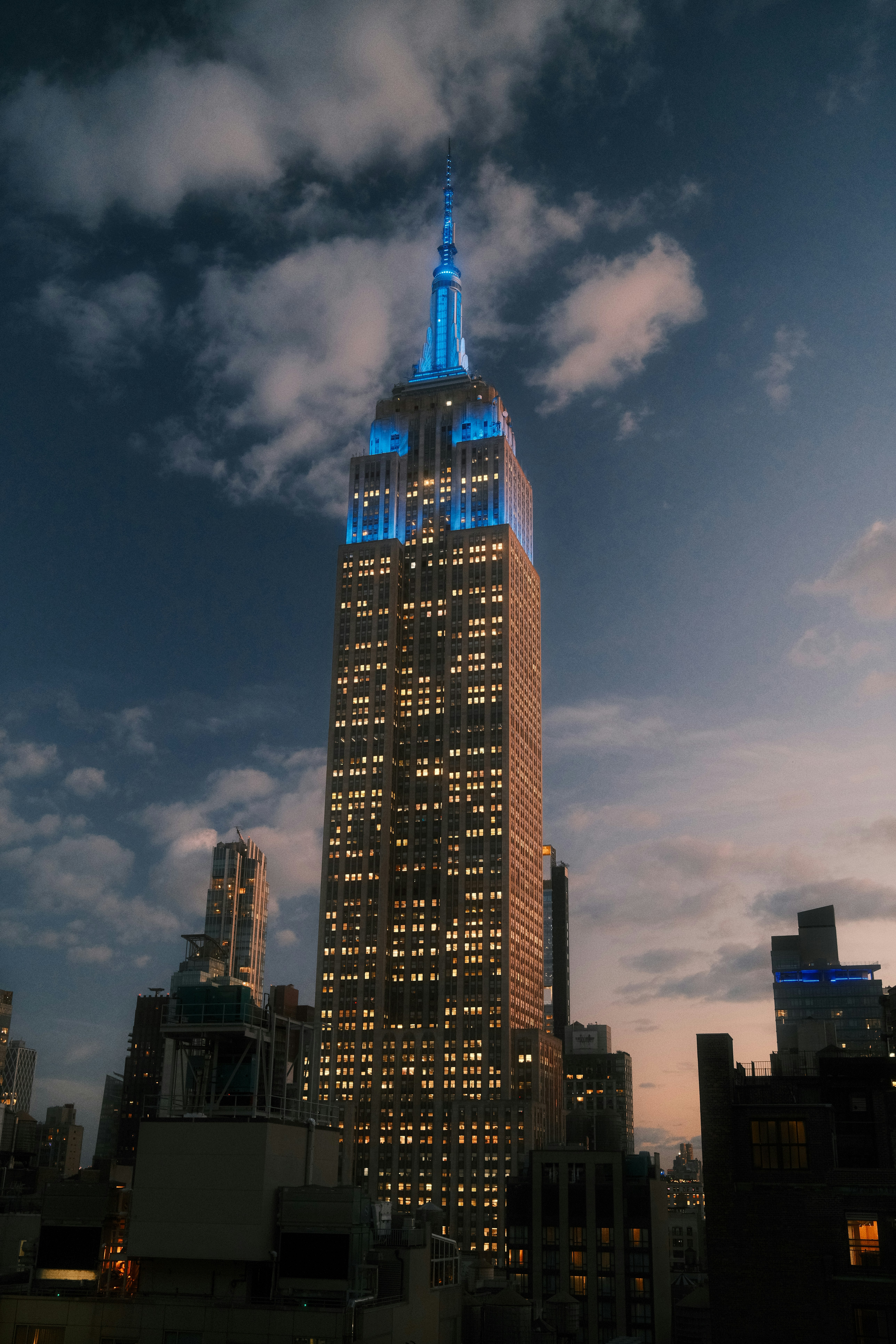 The Empire State Building illuminated with blue light at night in New York City