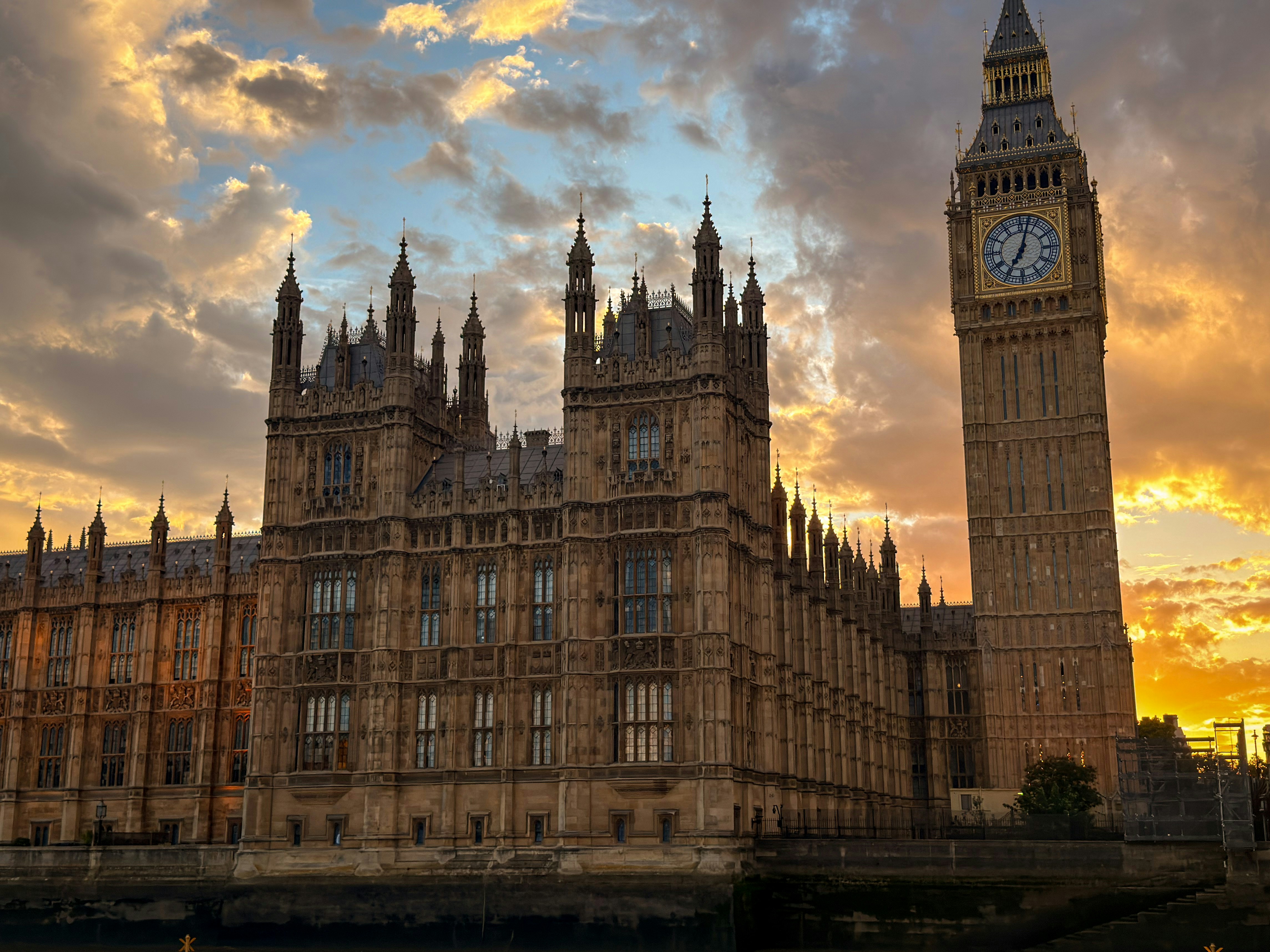 Big Ben and the Houses of Parliament in London under a golden hour sky