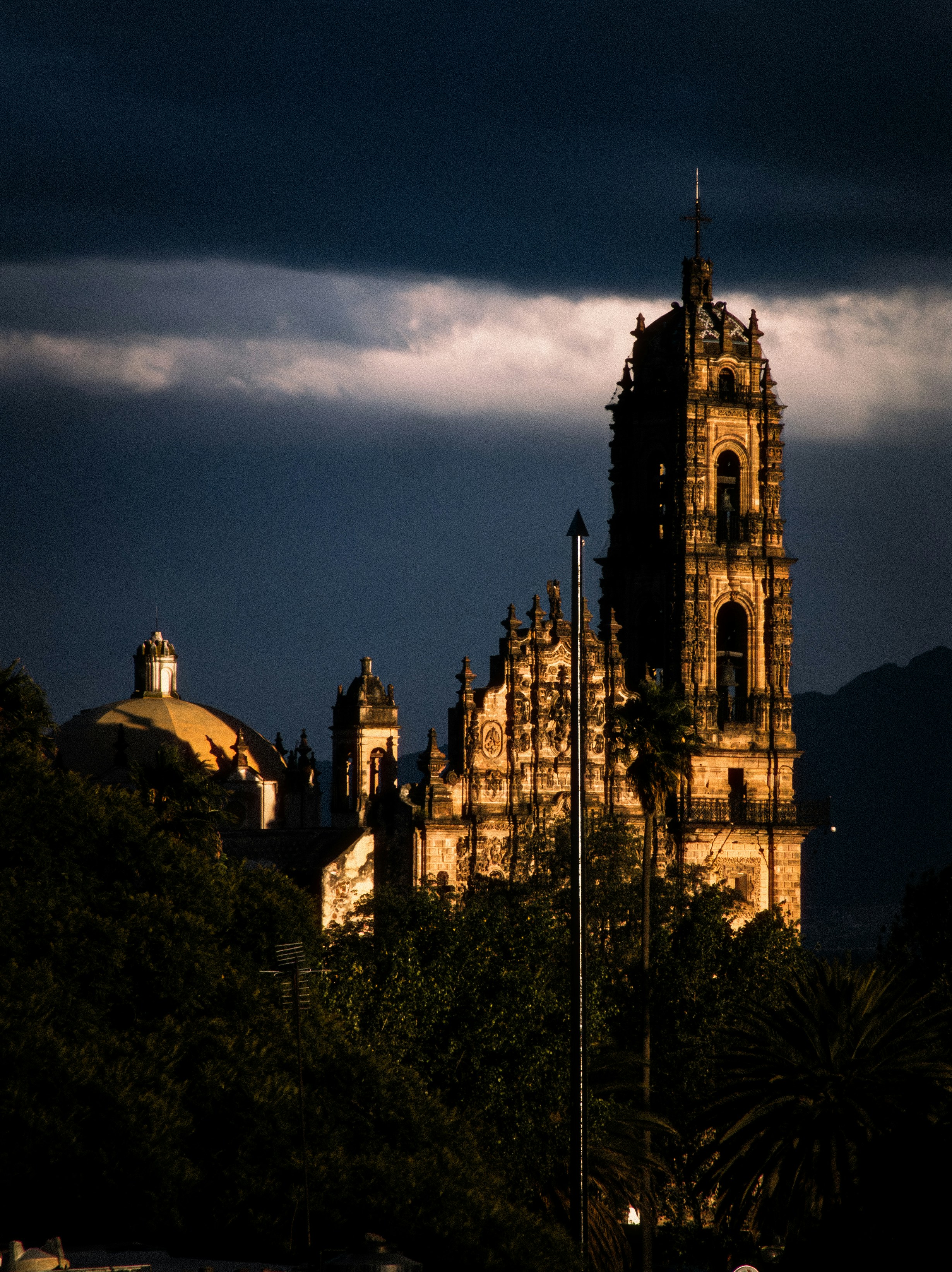 A colonial church tower in Tepotzotlán in low evening light