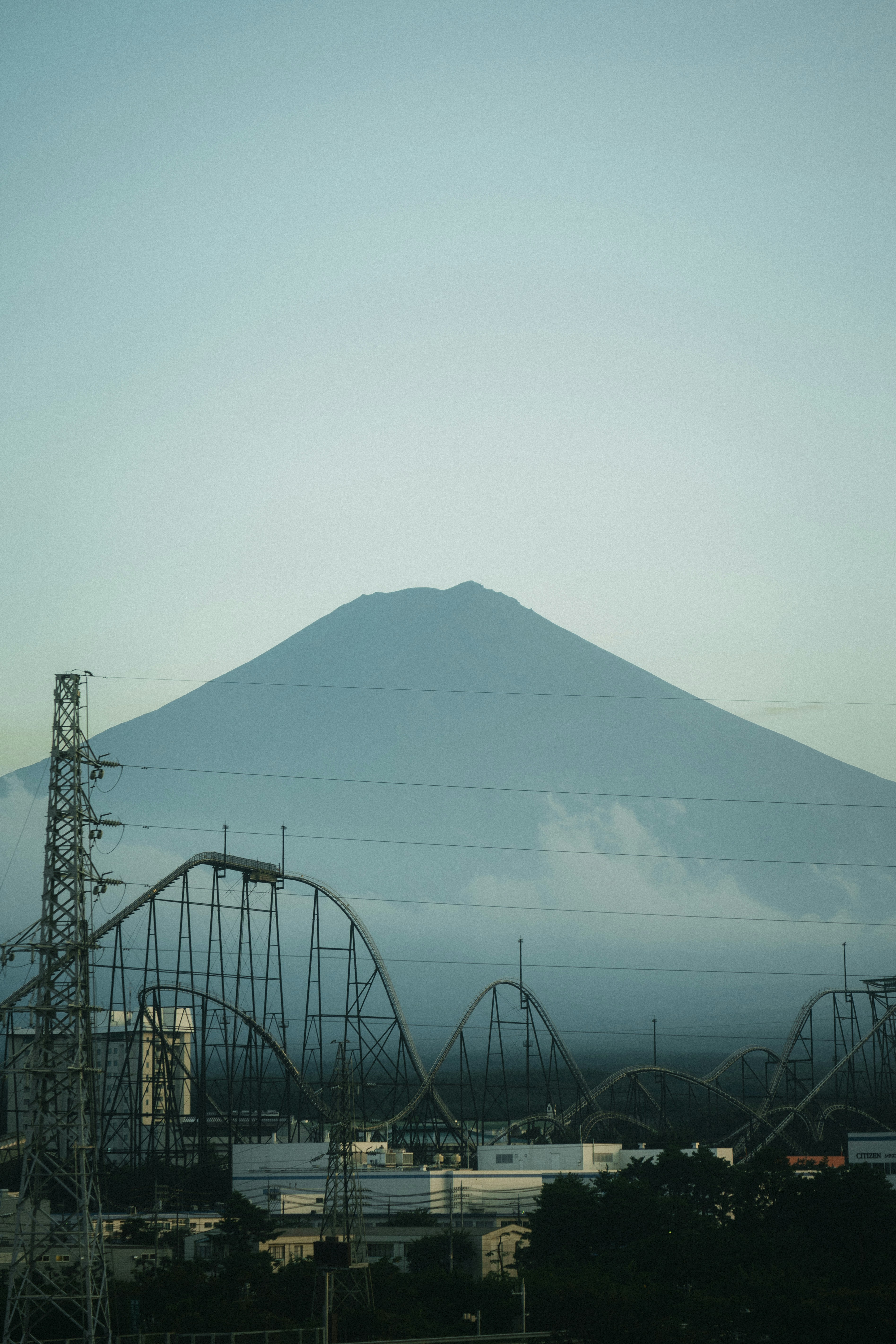 Mount Fuji rising behind a roller coaster and power lines in Japan — Redd Francisco