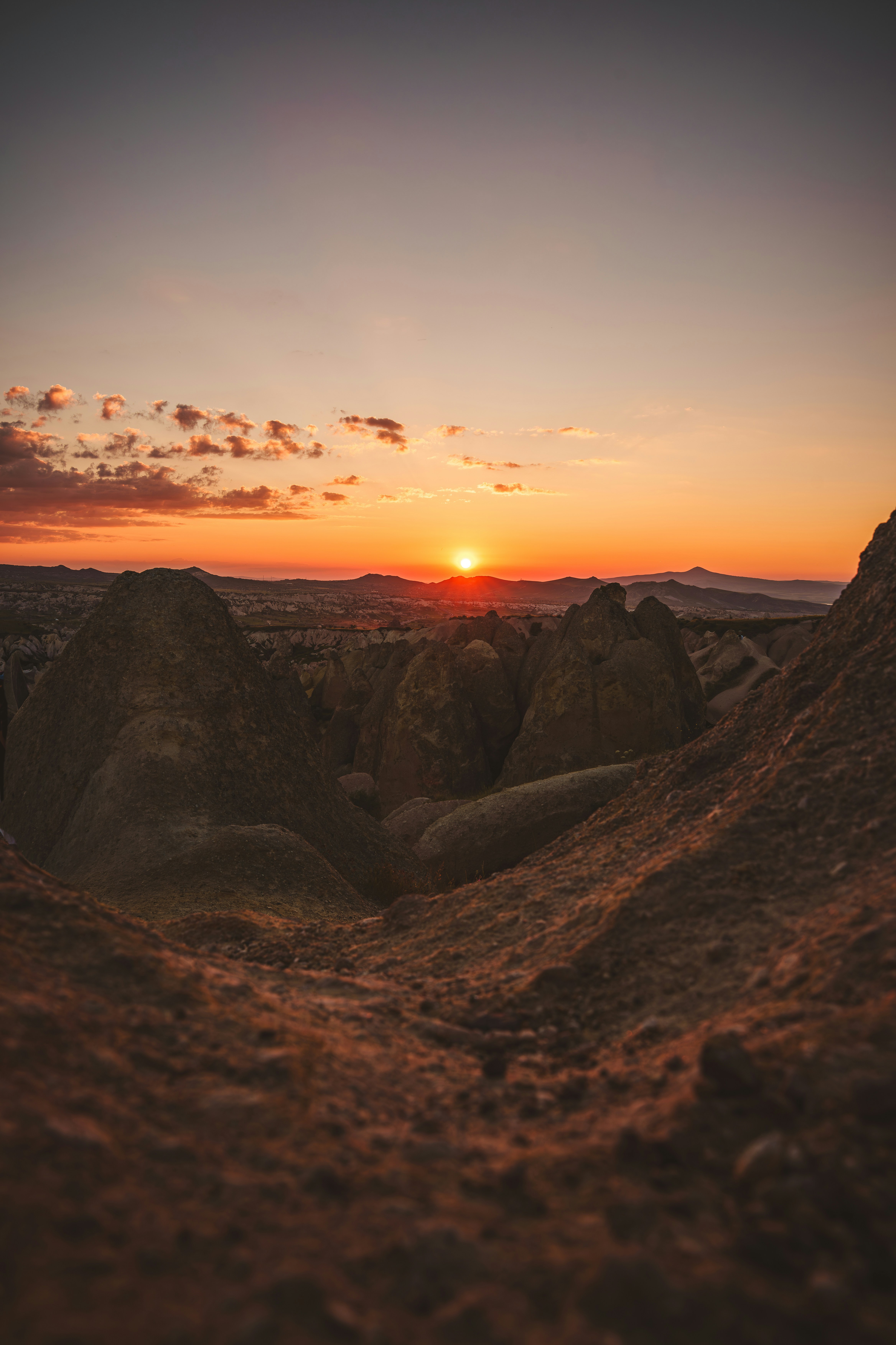 Low sun over rocky volcanic formations in Cappadocia, Turkey