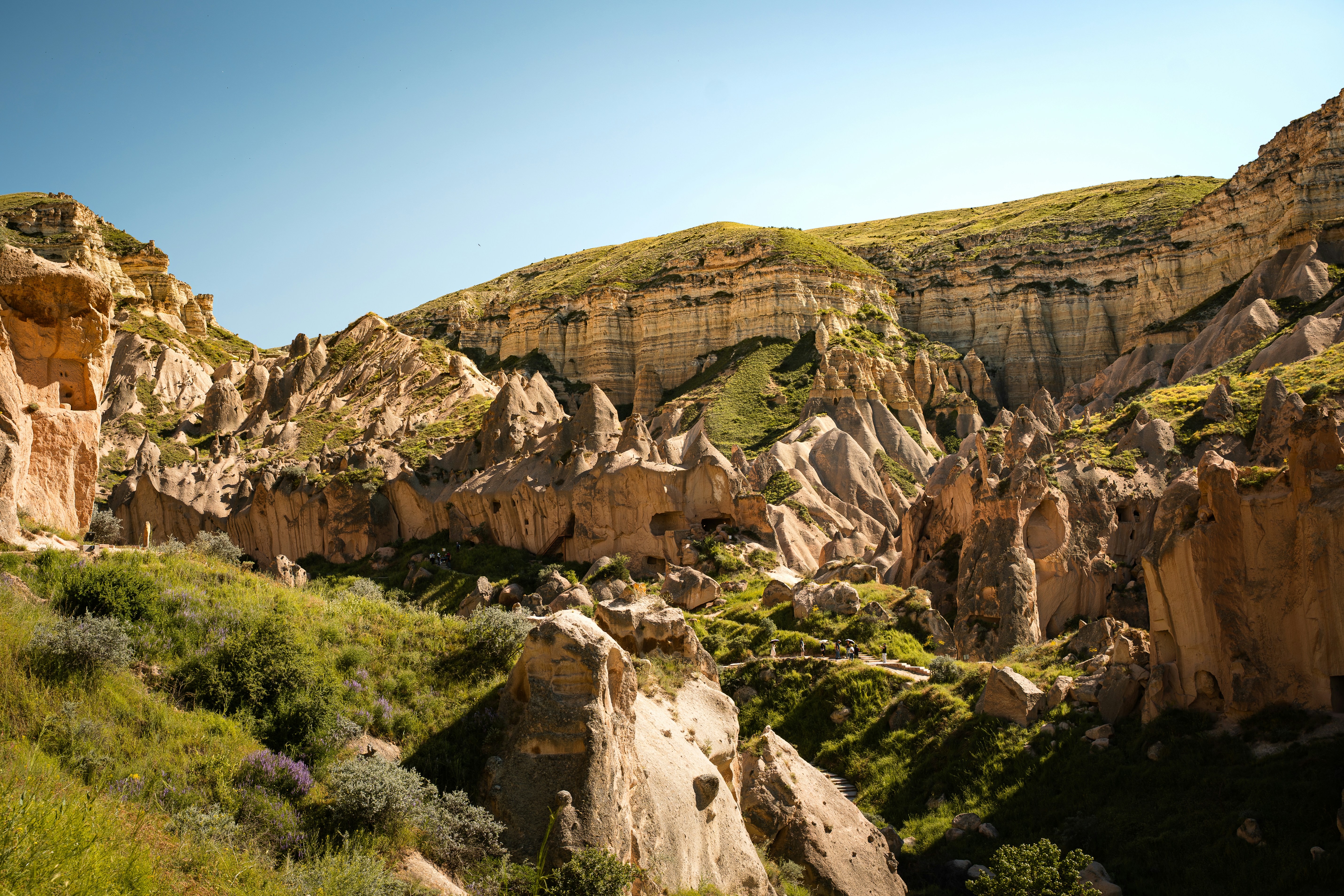 Eroded rock formations and green hills in the Zemi Valley of Cappadocia, Turkey