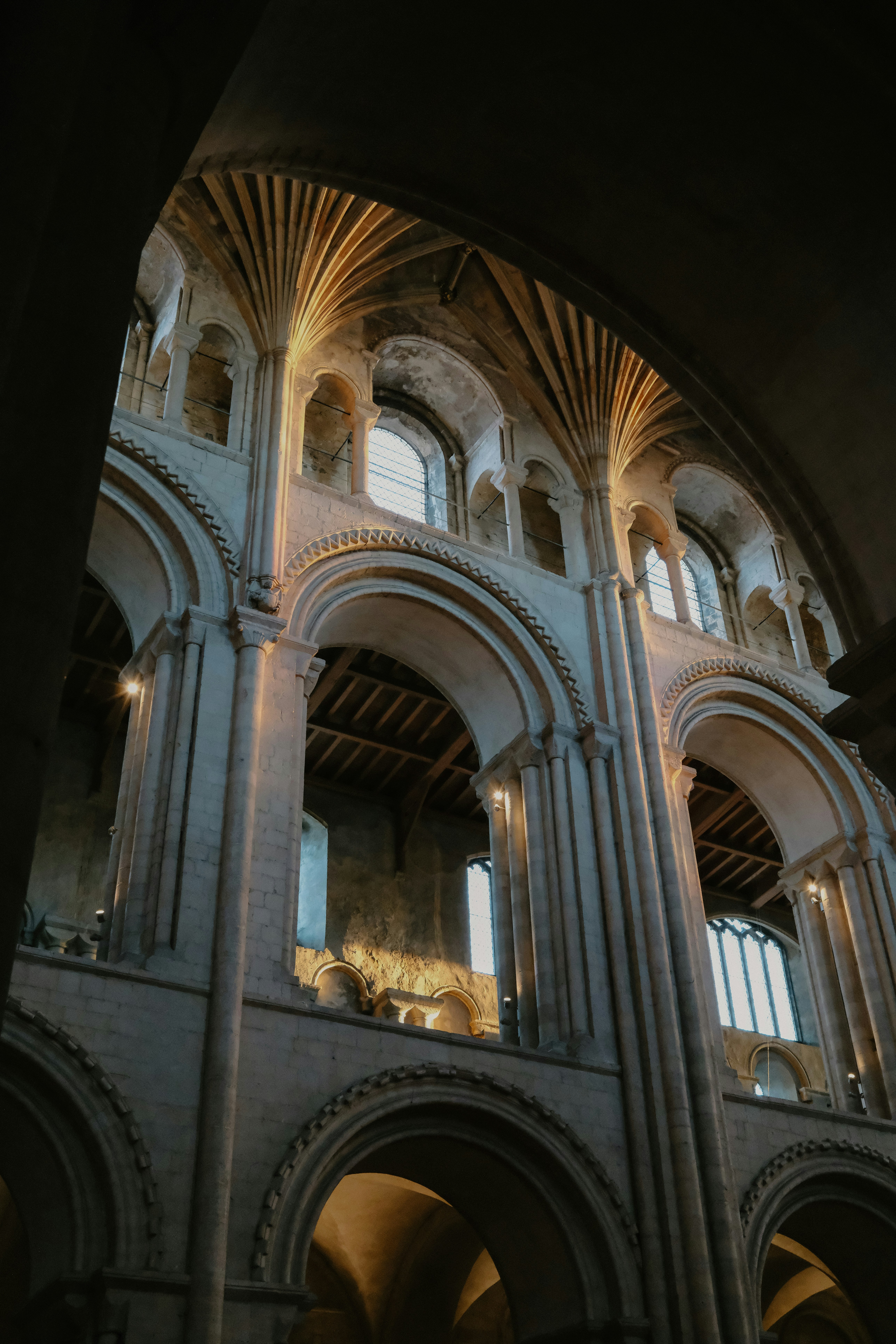 Stone arches and vaulted ceilings in a historic cathedral with warm light
