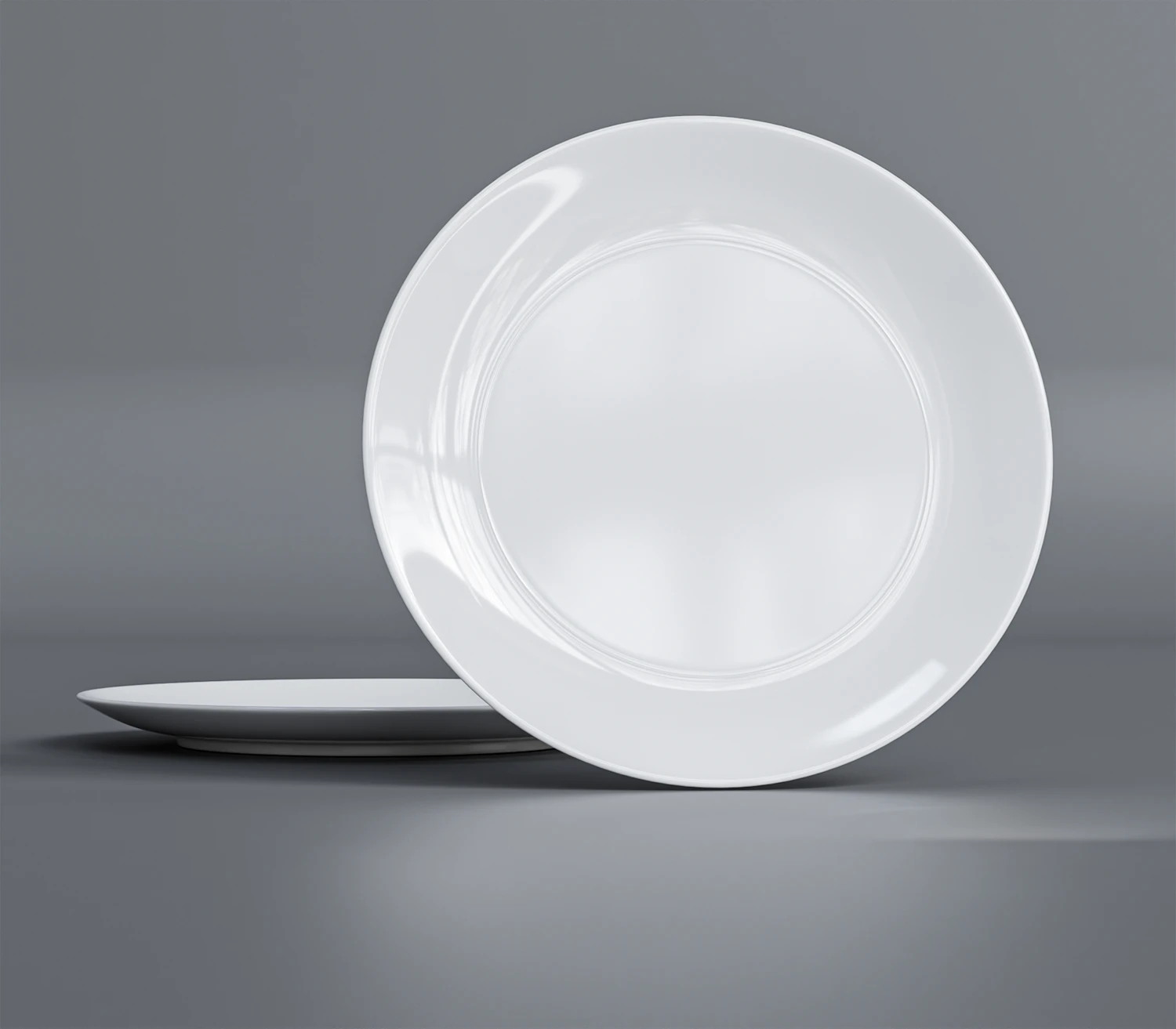 Pietra platter in salt glaze, a wide pale dish resting against a second plate on a grey ground