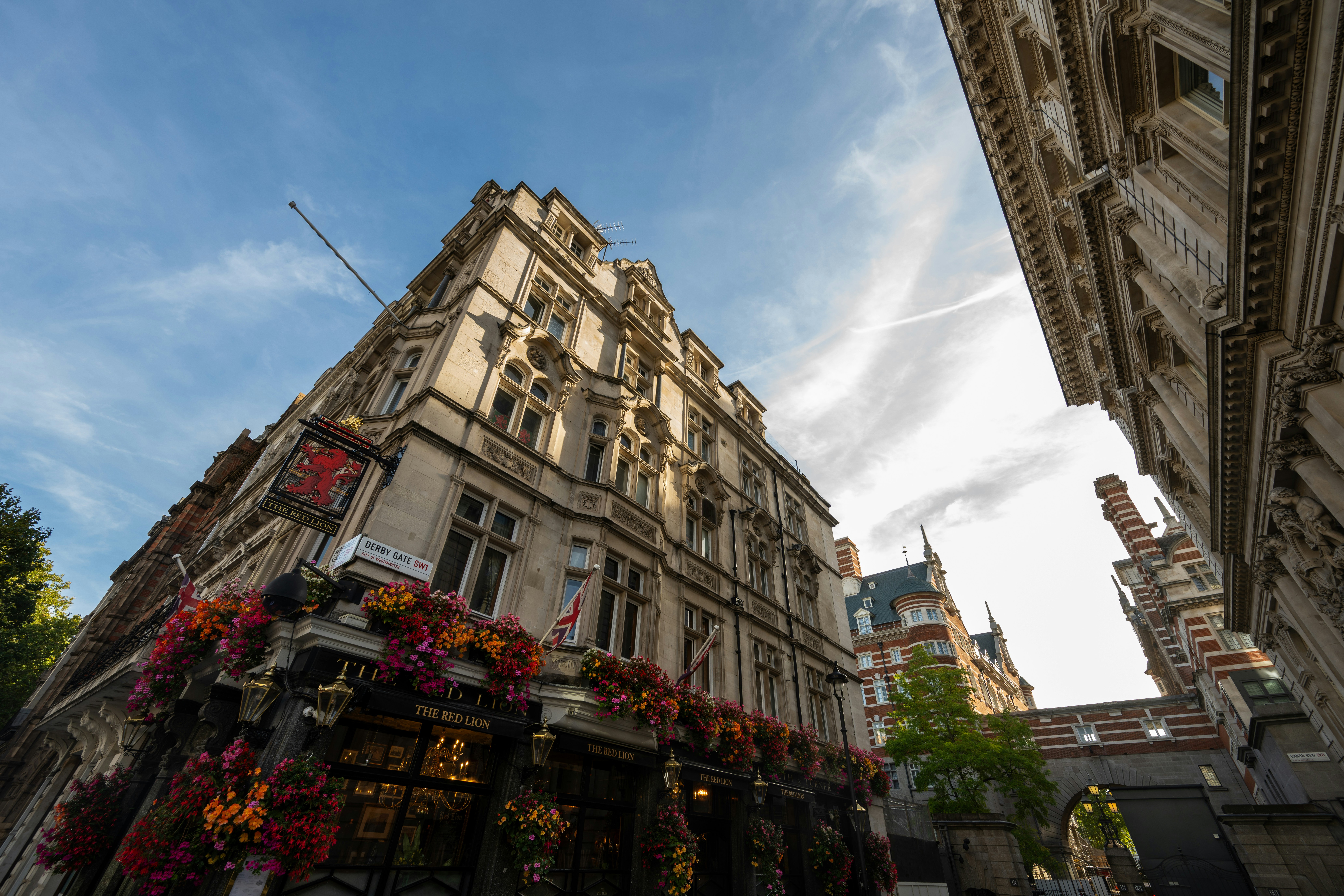 The Red Lion pub with hanging flower baskets on a street in London