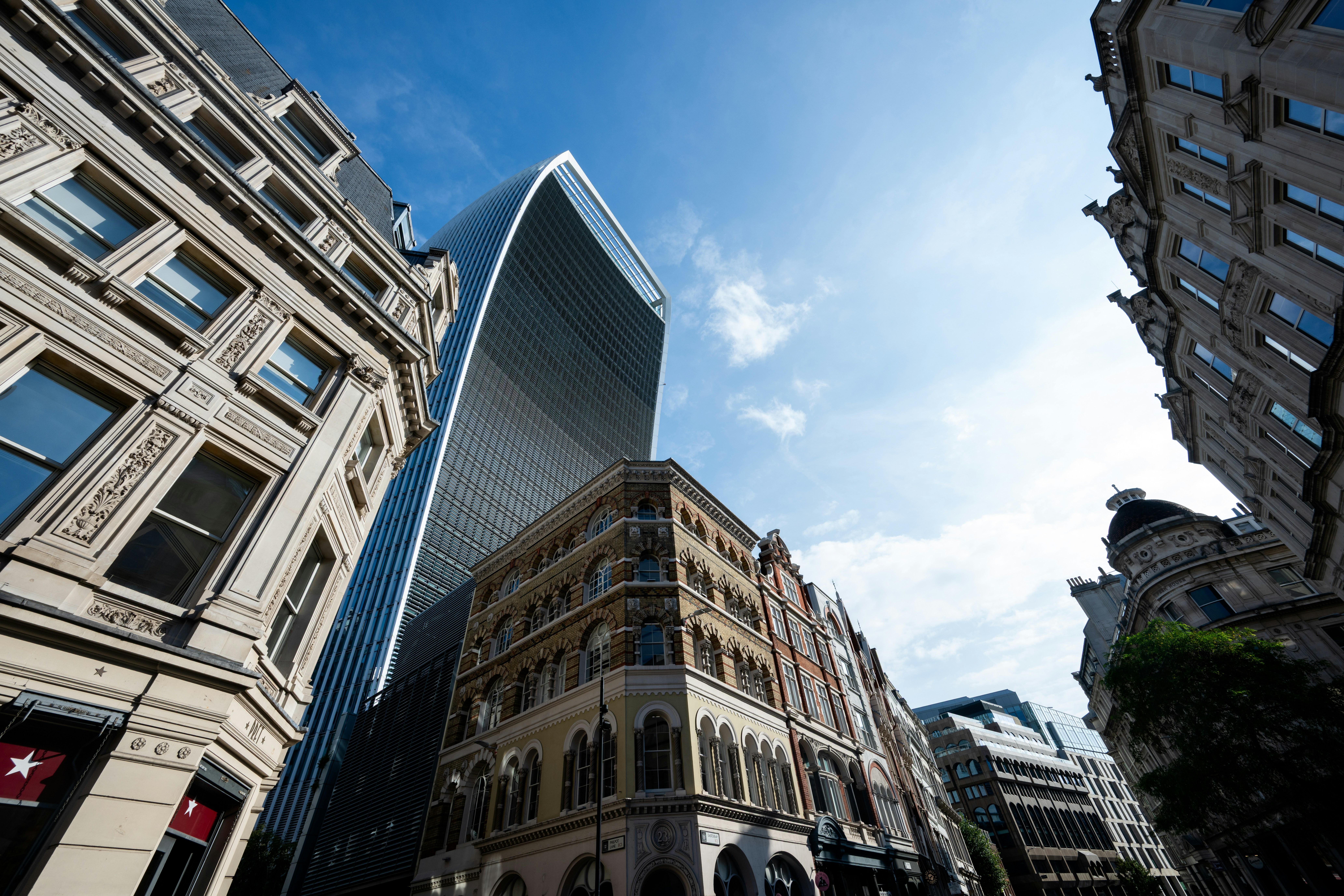 The Walkie Talkie building rising above historic stone architecture in London