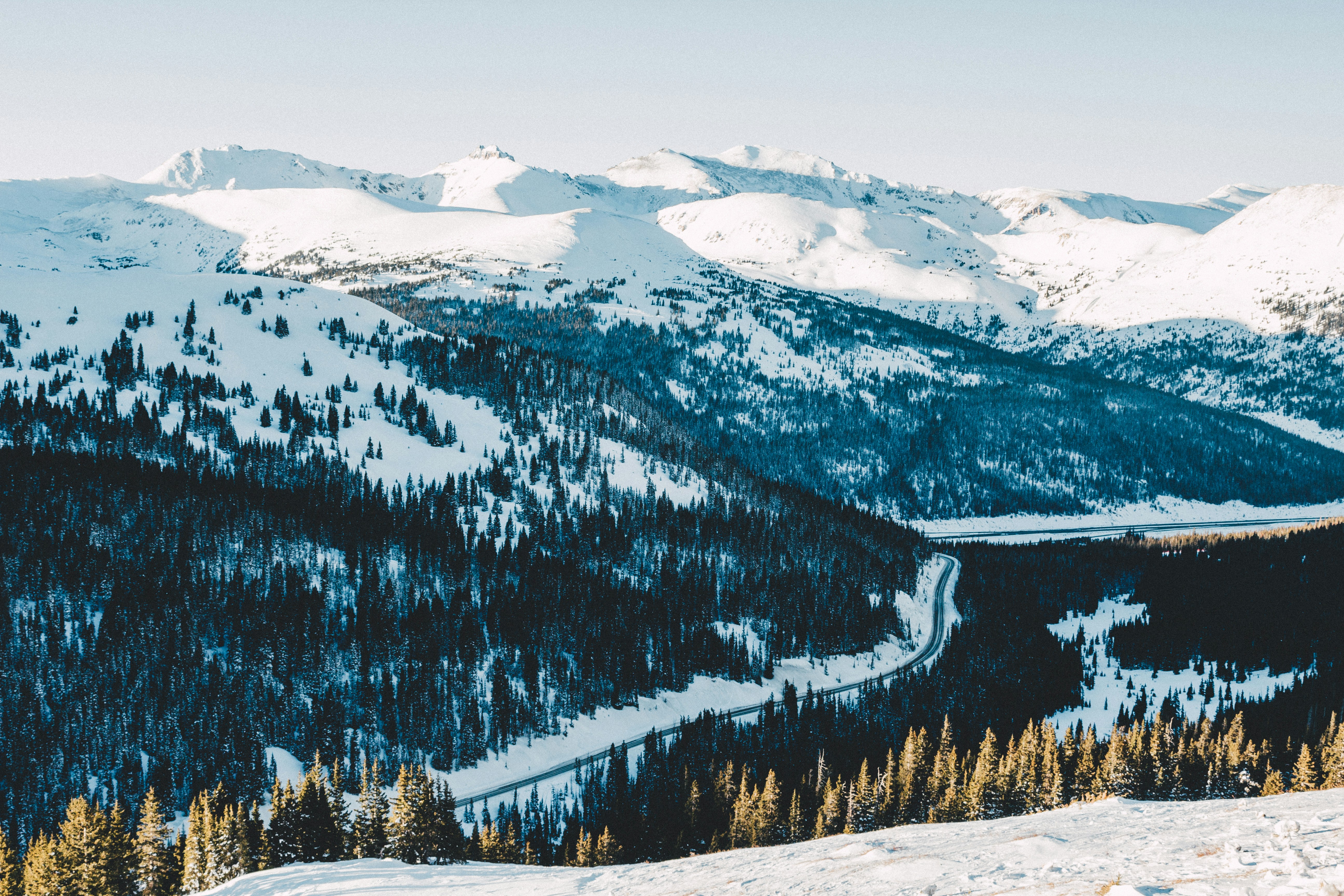 Winding road through snowy mountain forest - Free Photo on Unsplash