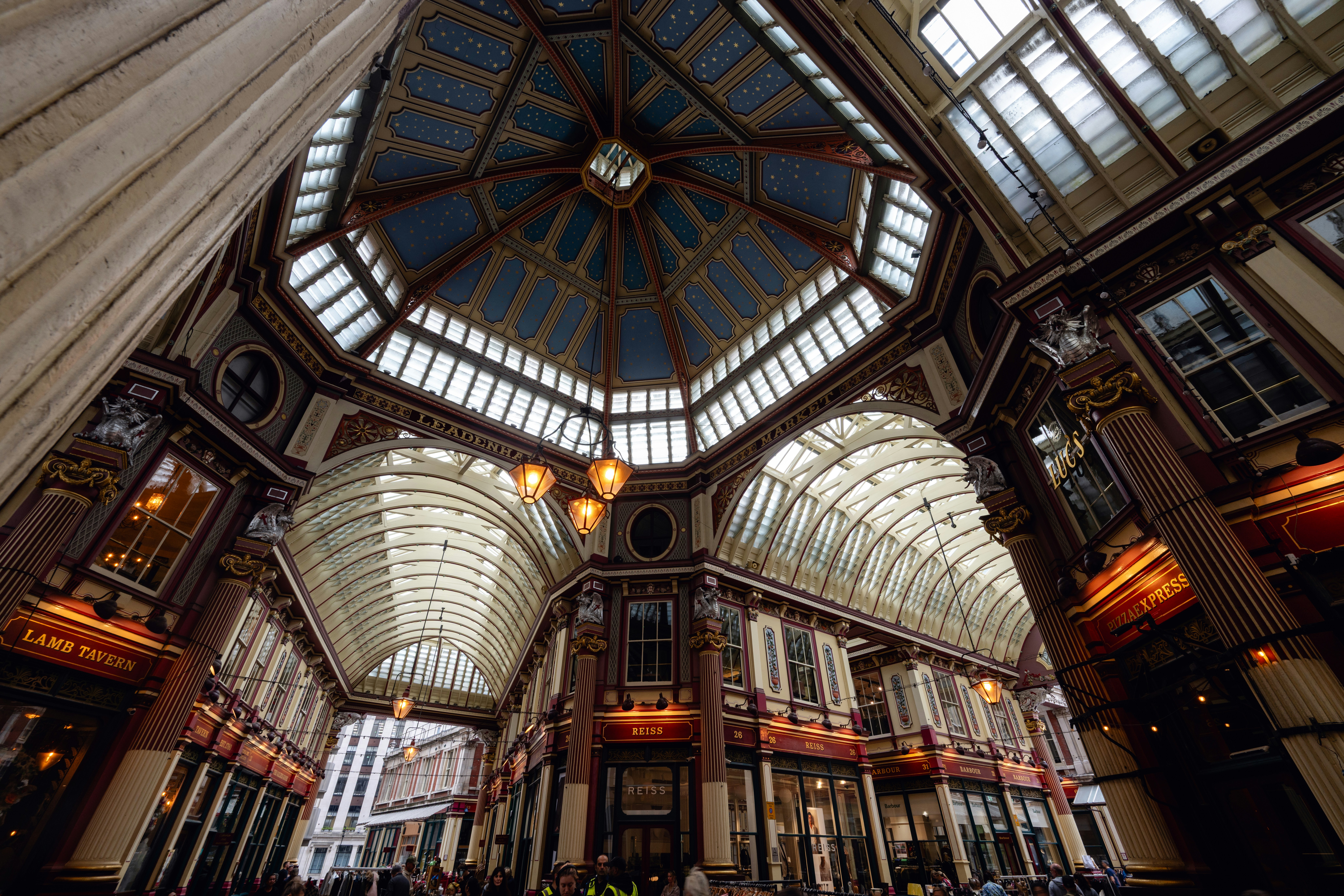 The ornate vaulted ceiling and storefronts of Leadenhall Market in London