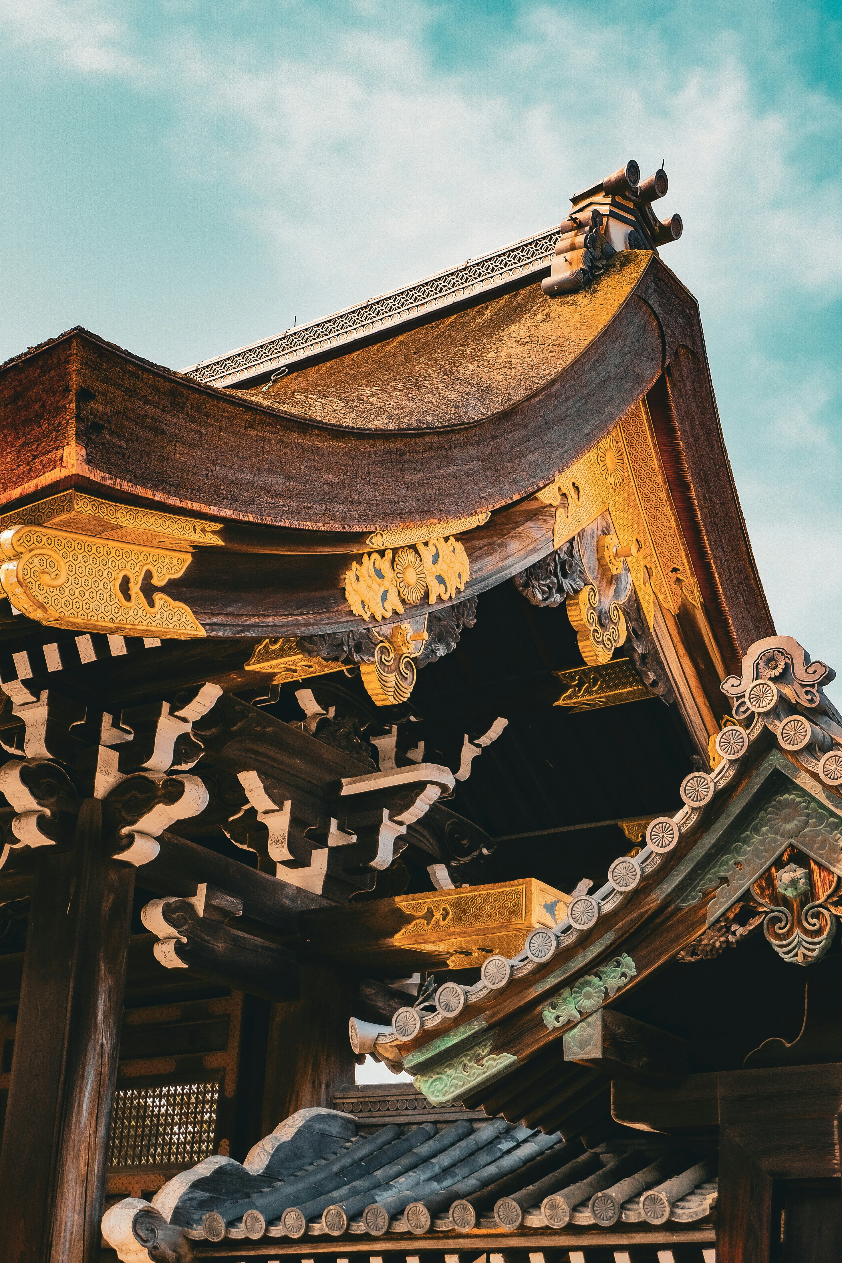 Ornate wooden roof with gold trim on a traditional Japanese temple building