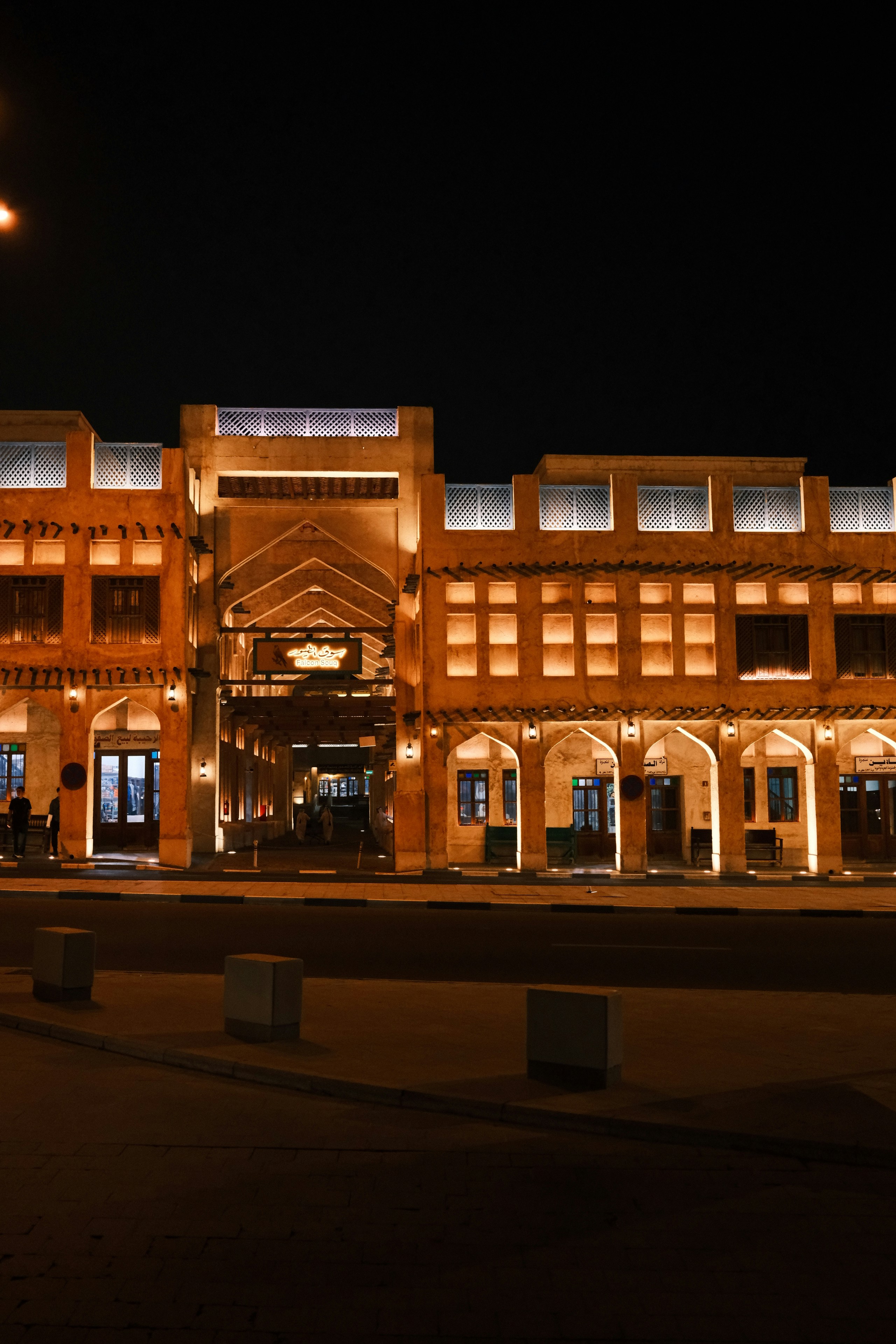 The illuminated facade of the Falcon Souq in Doha at night