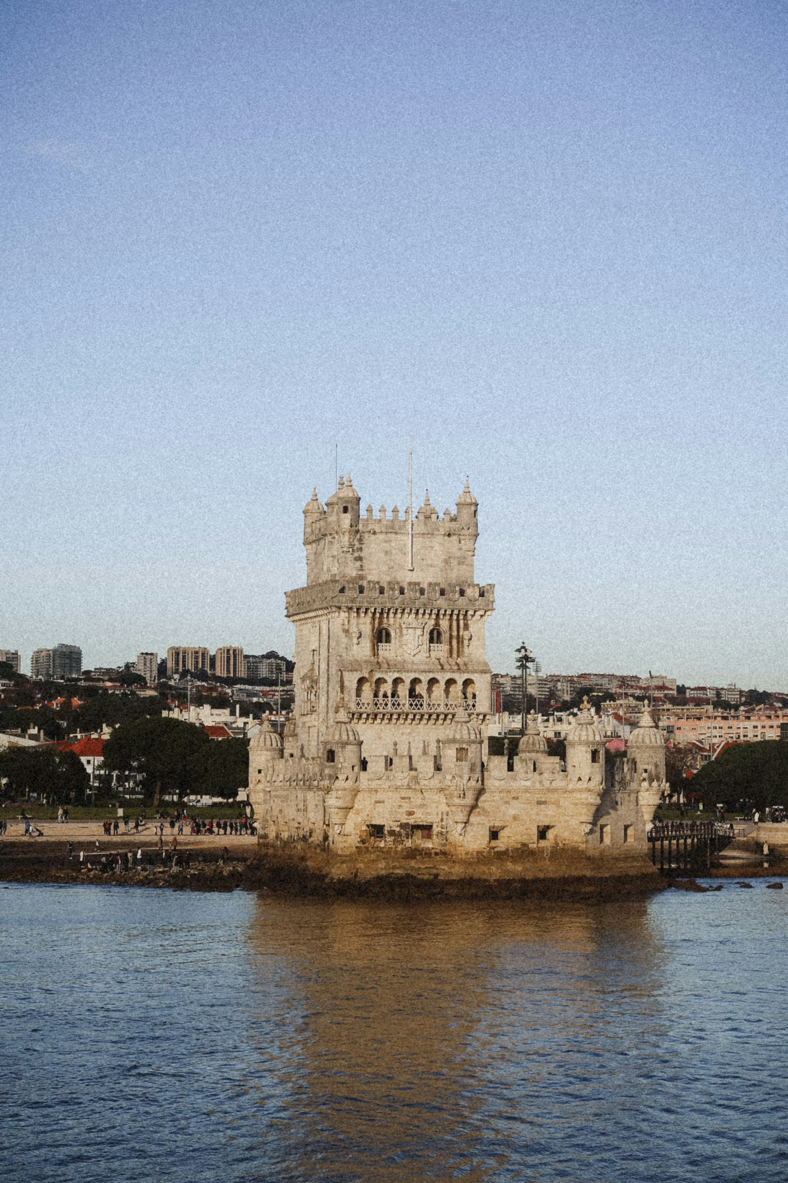 Belém Tower on the Tagus River in Lisbon with a city skyline behind
