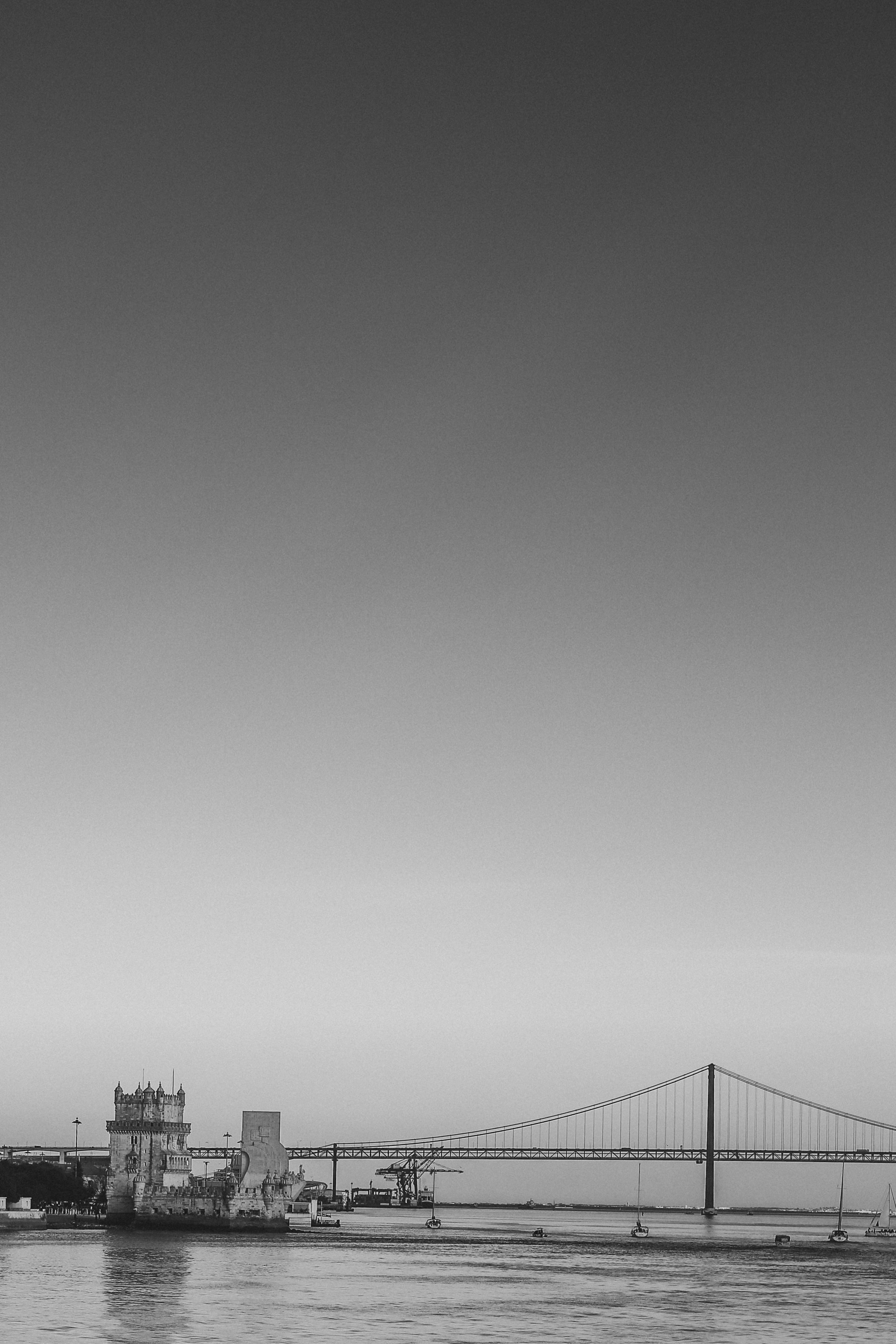 The Belém Tower and 25 de Abril Bridge on the Tagus River in Lisbon