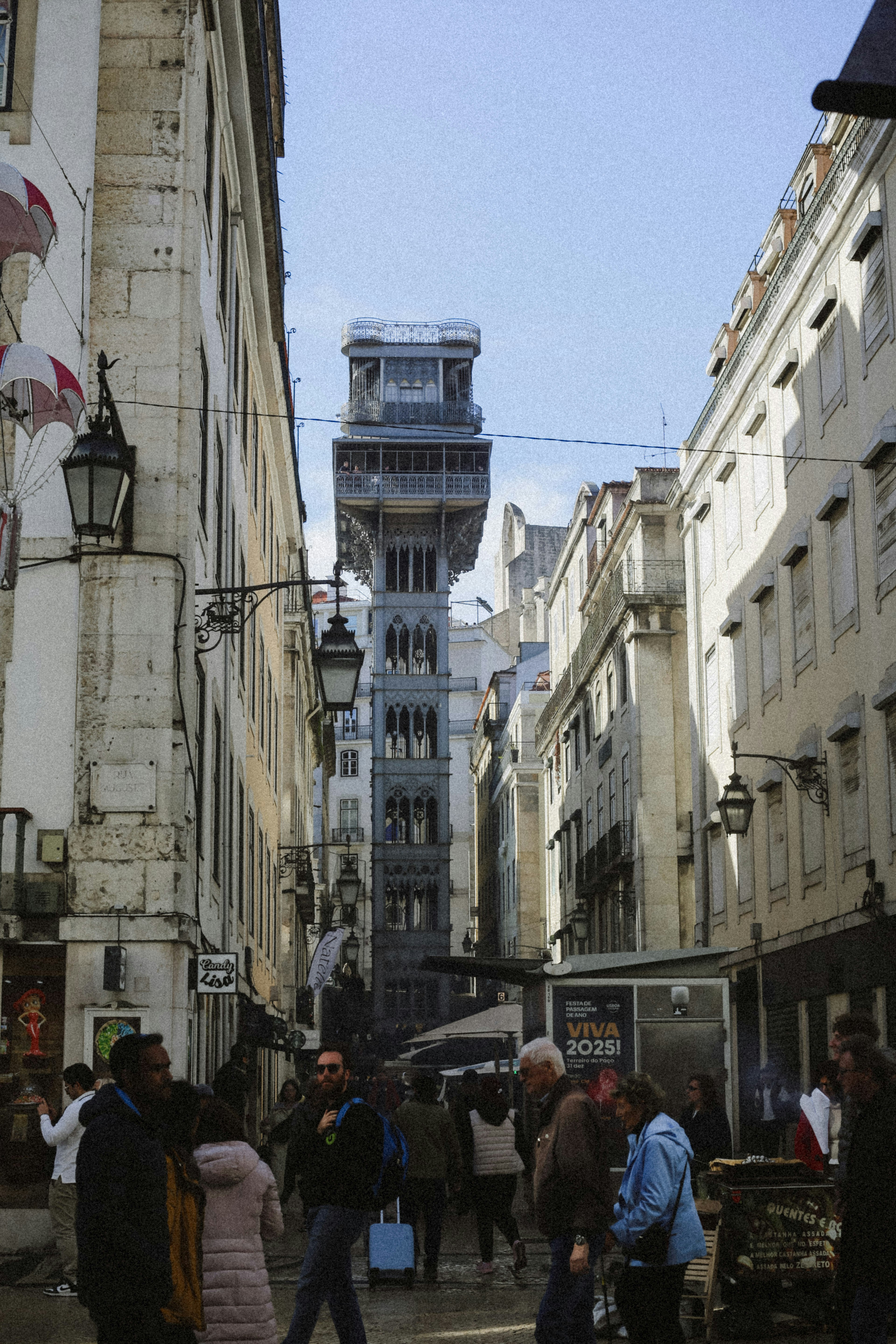 The Santa Justa Lift rising above a narrow street in Lisbon, Portugal