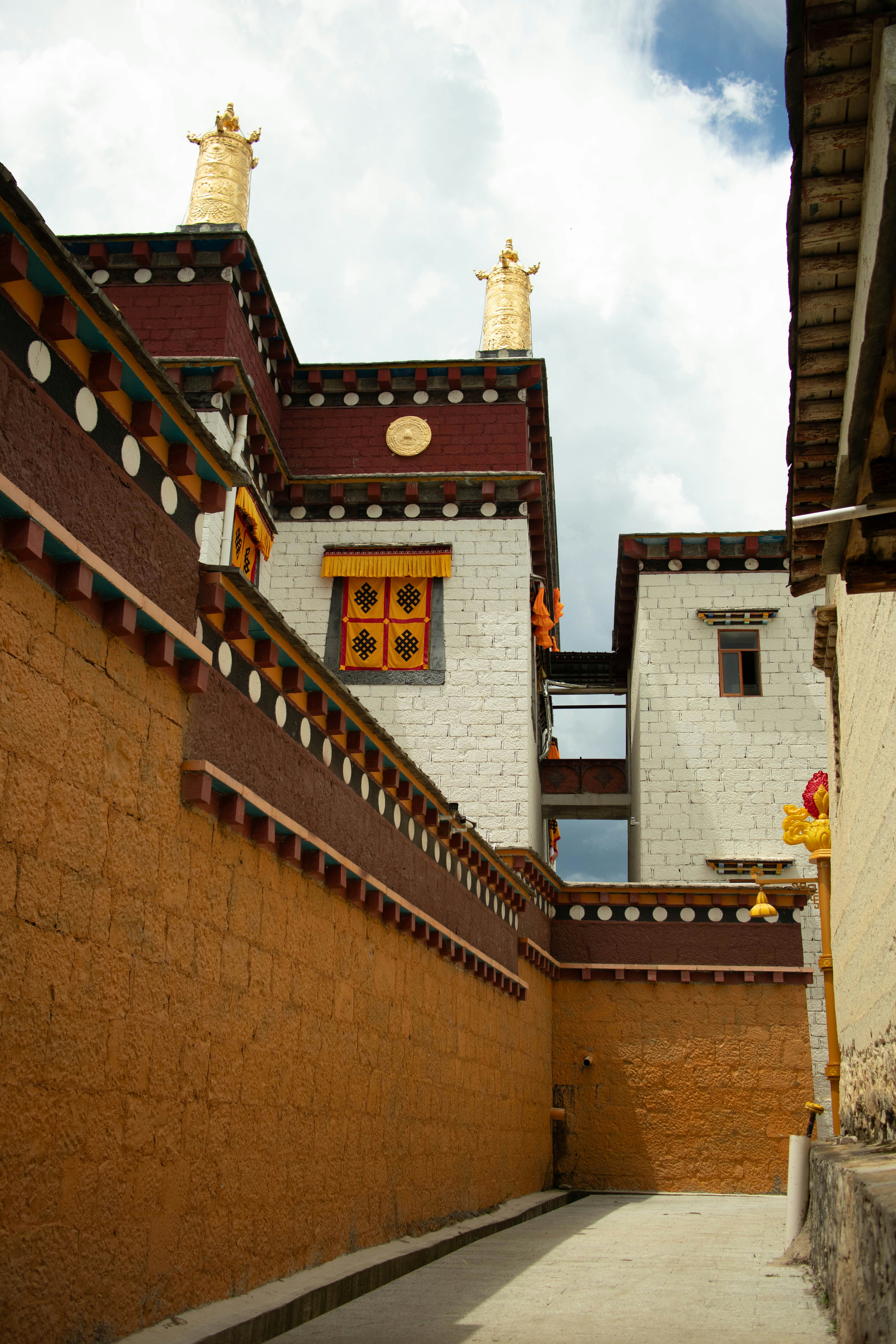 Tibetan monastery buildings with stone walkway - Free Photo on Unsplash