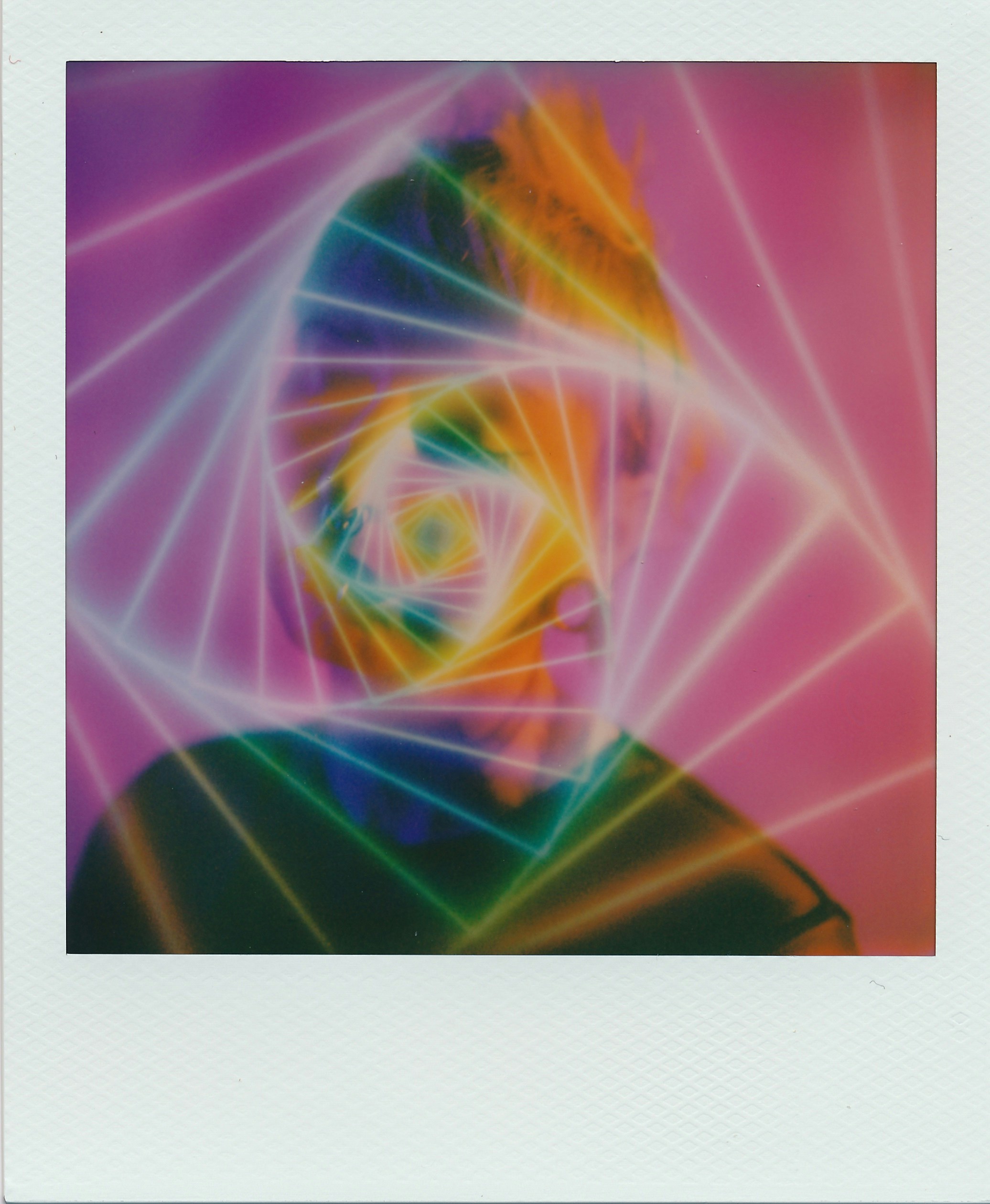A person in silhouette behind a glowing neon spiral of light