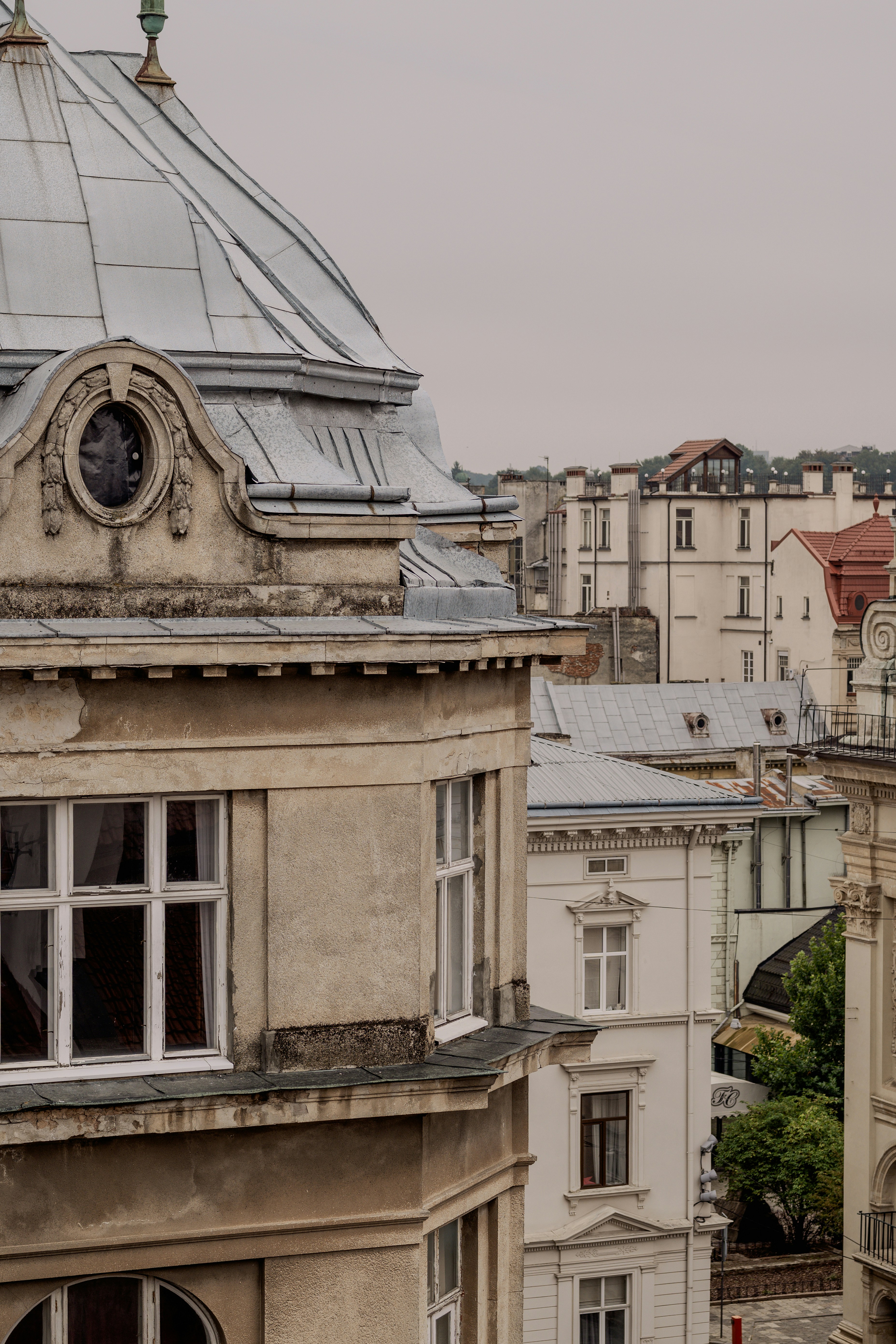 A weathered building with a domed roof overlooking a dense urban cityscape