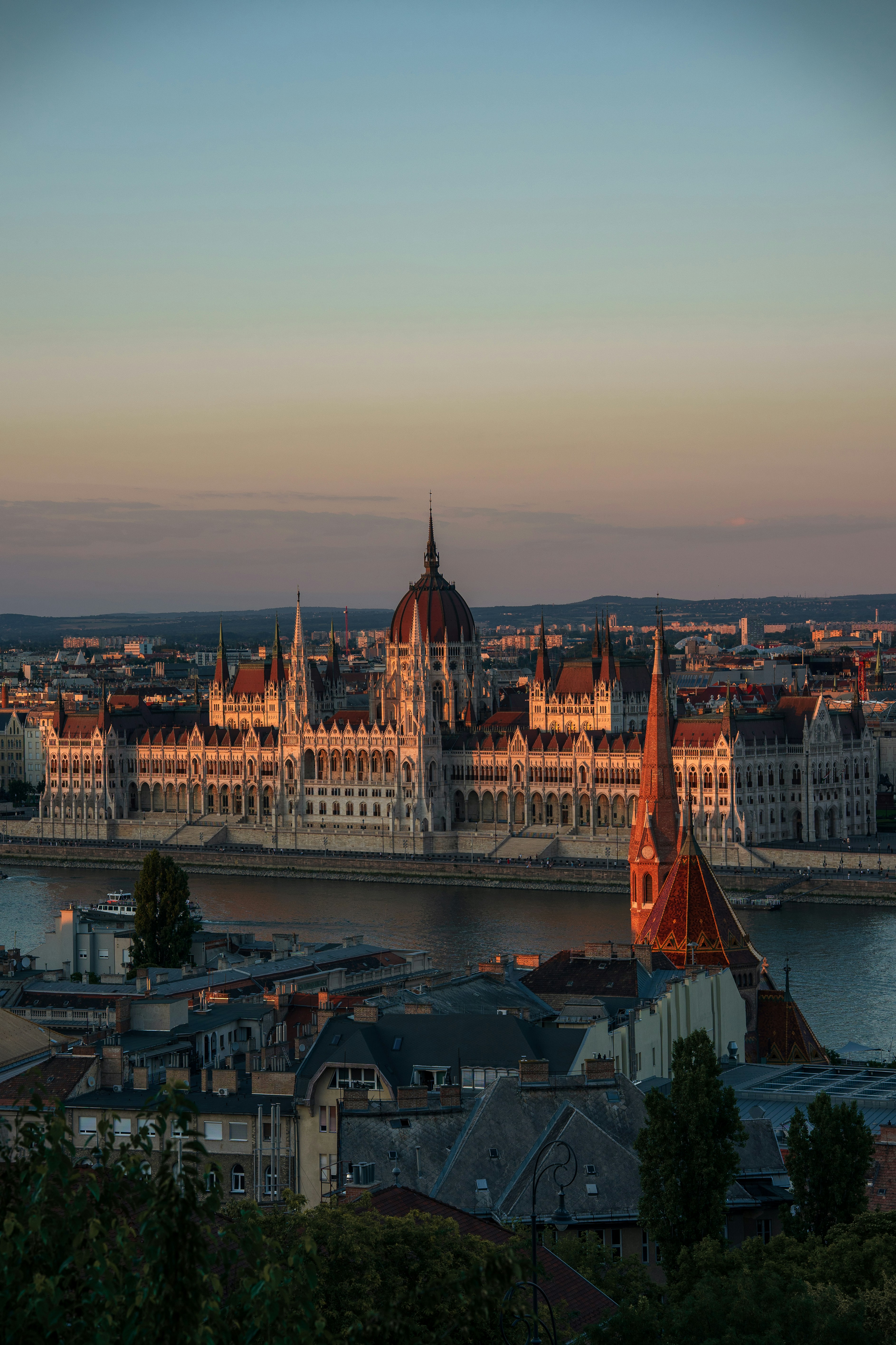 The Hungarian Parliament Building on the Danube river in Budapest at golden hour