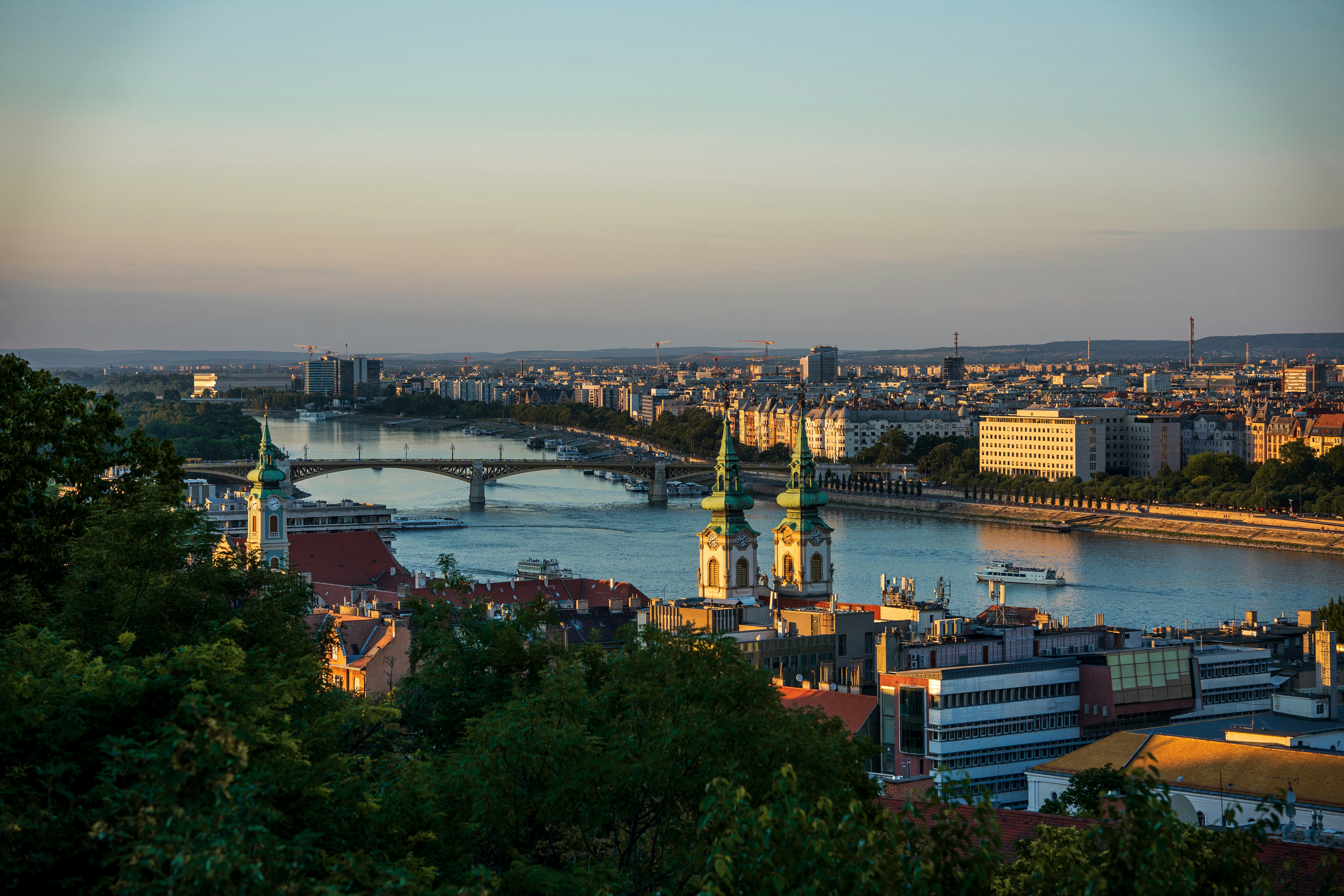 The Danube river flowing through Budapest with the Margaret Bridge and church spires