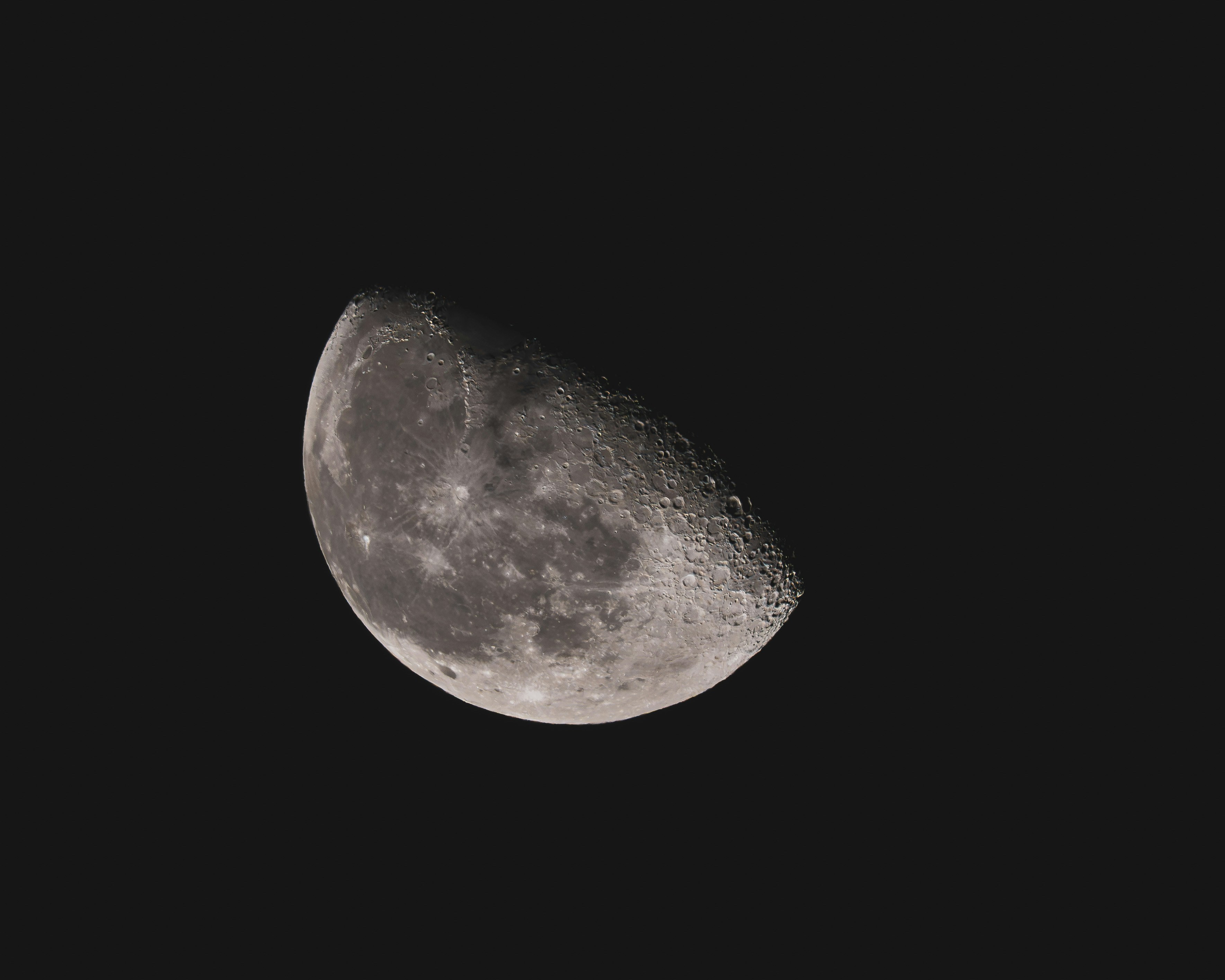 A waxing gibbous moon showing craters and lunar maria against a black sky