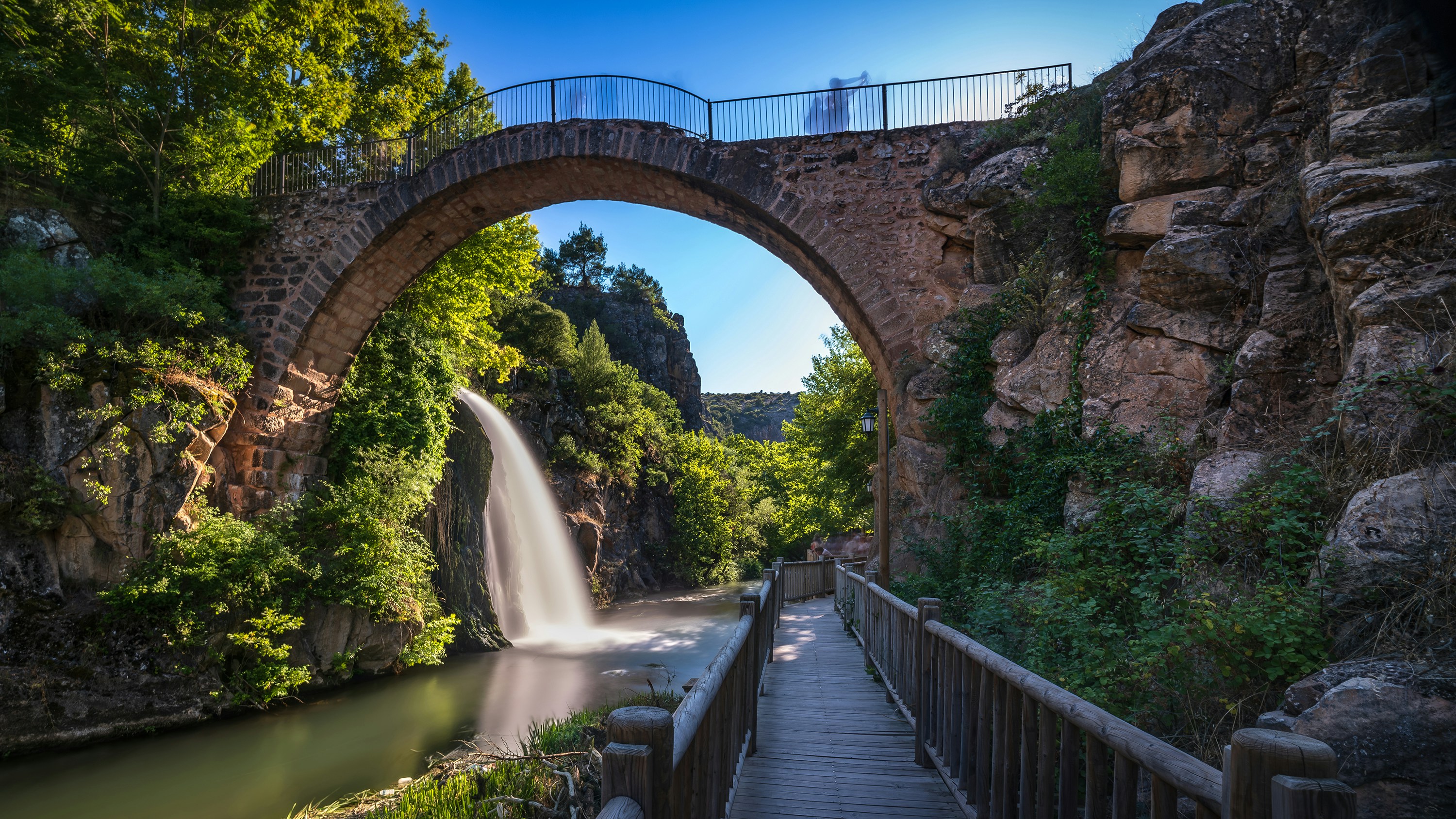 Stone arch bridge over waterfall - Free Photo on Unsplash