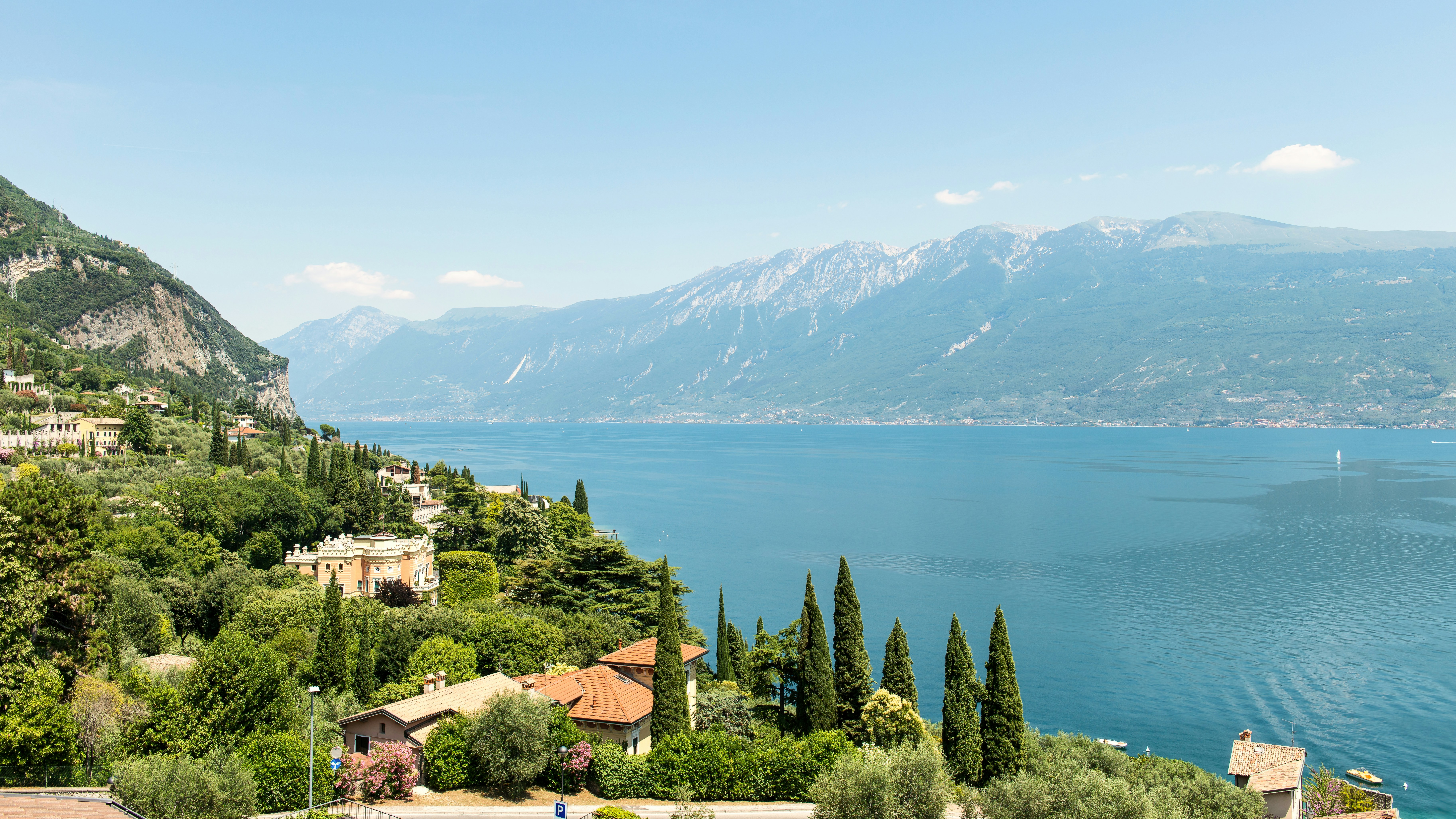 Villas nestled among trees on a hillside overlooking Lake Garda in Italy