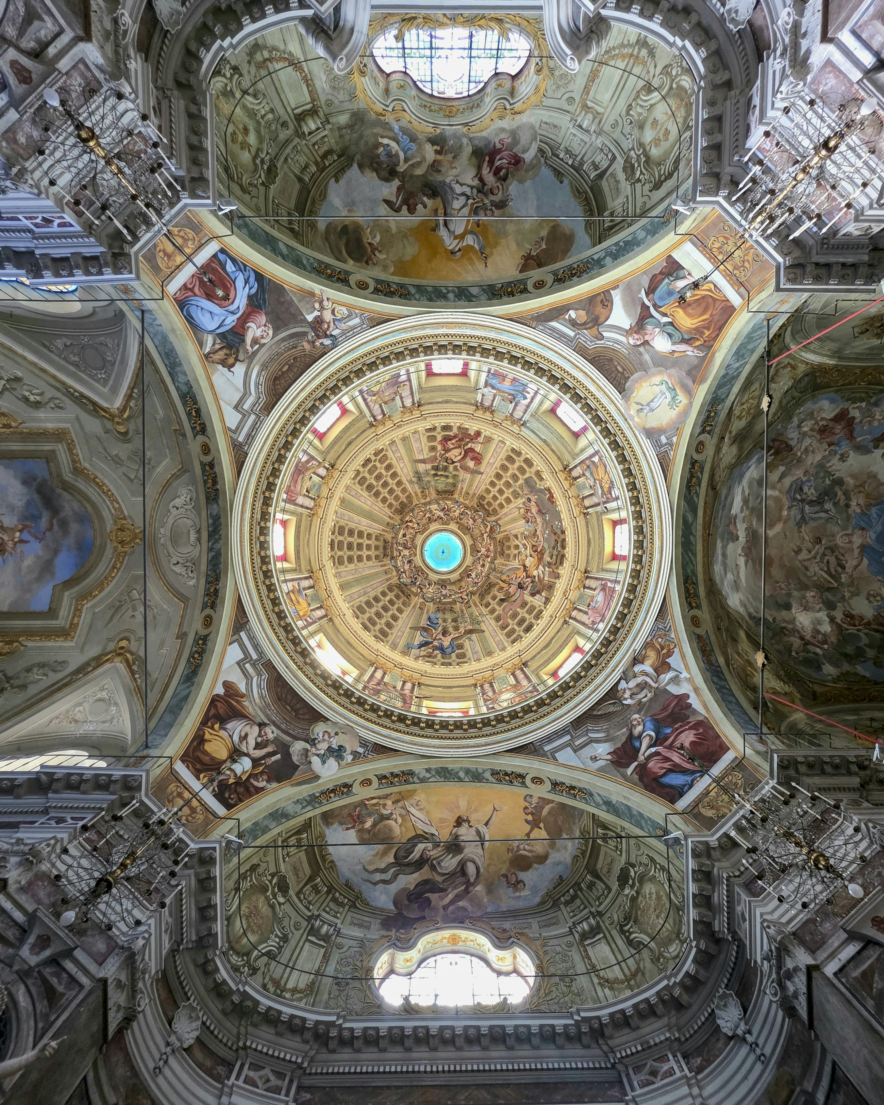 Ornate frescoed dome and vaulted ceiling of a historic church interior