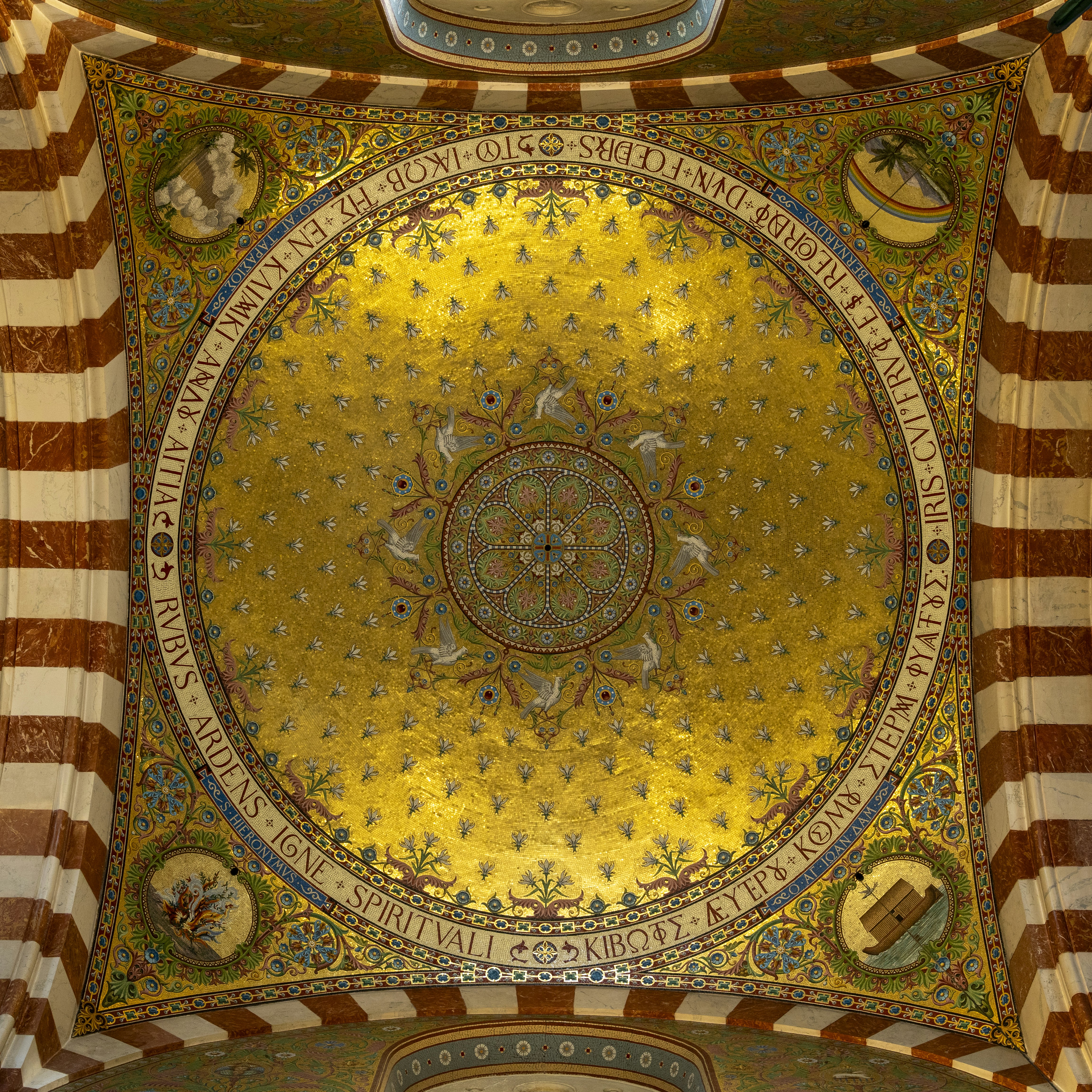 A golden mosaic ceiling with white doves and floral patterns in a vaulted arch