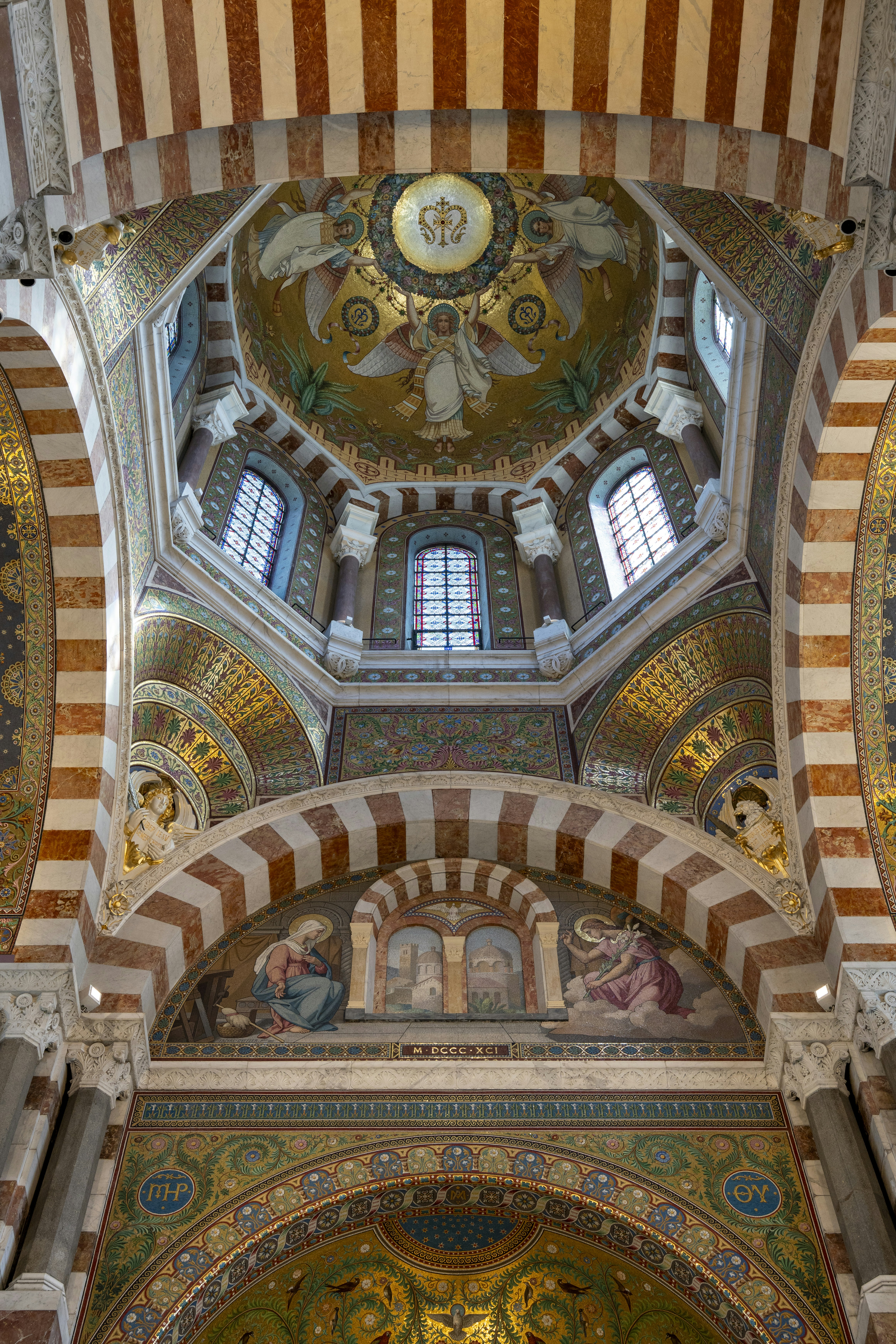Ornate interior of the Basilique Notre-Dame de la Garde in Marseille with golden mosaics