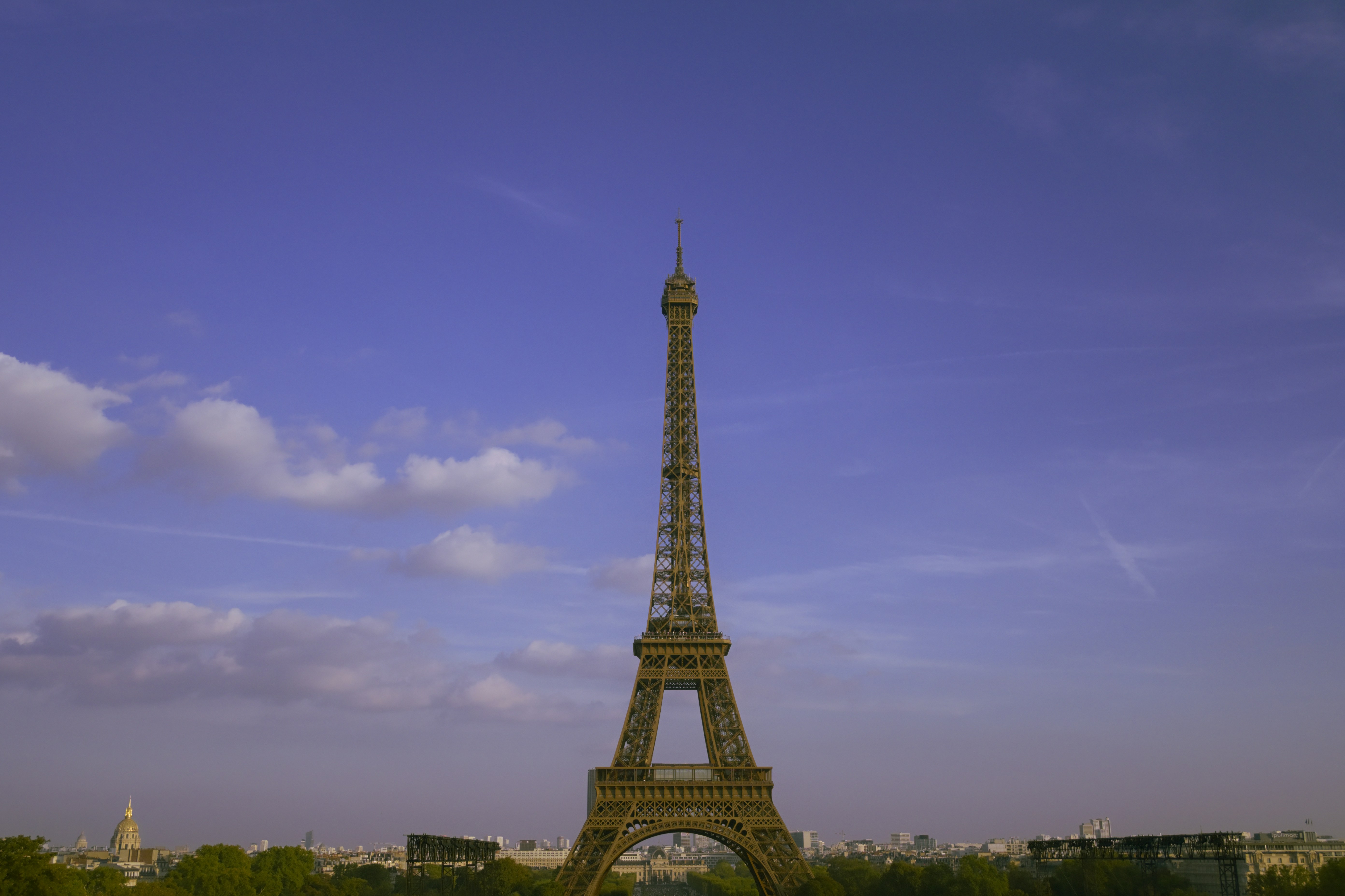 The Eiffel Tower rising above the Paris skyline under a clear blue sky