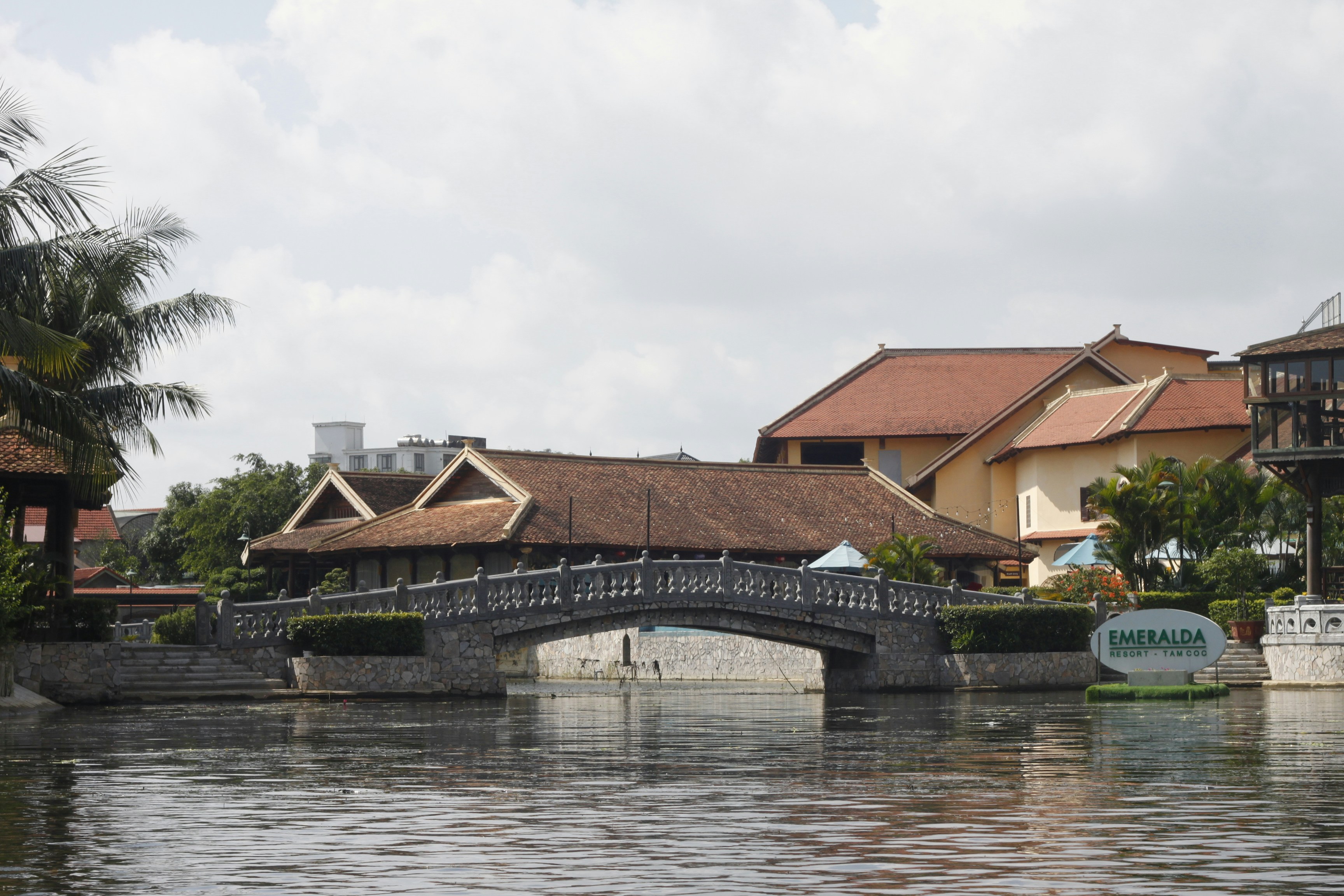 A stone arched bridge over a canal at the Emeralda Resort in Tam Coc