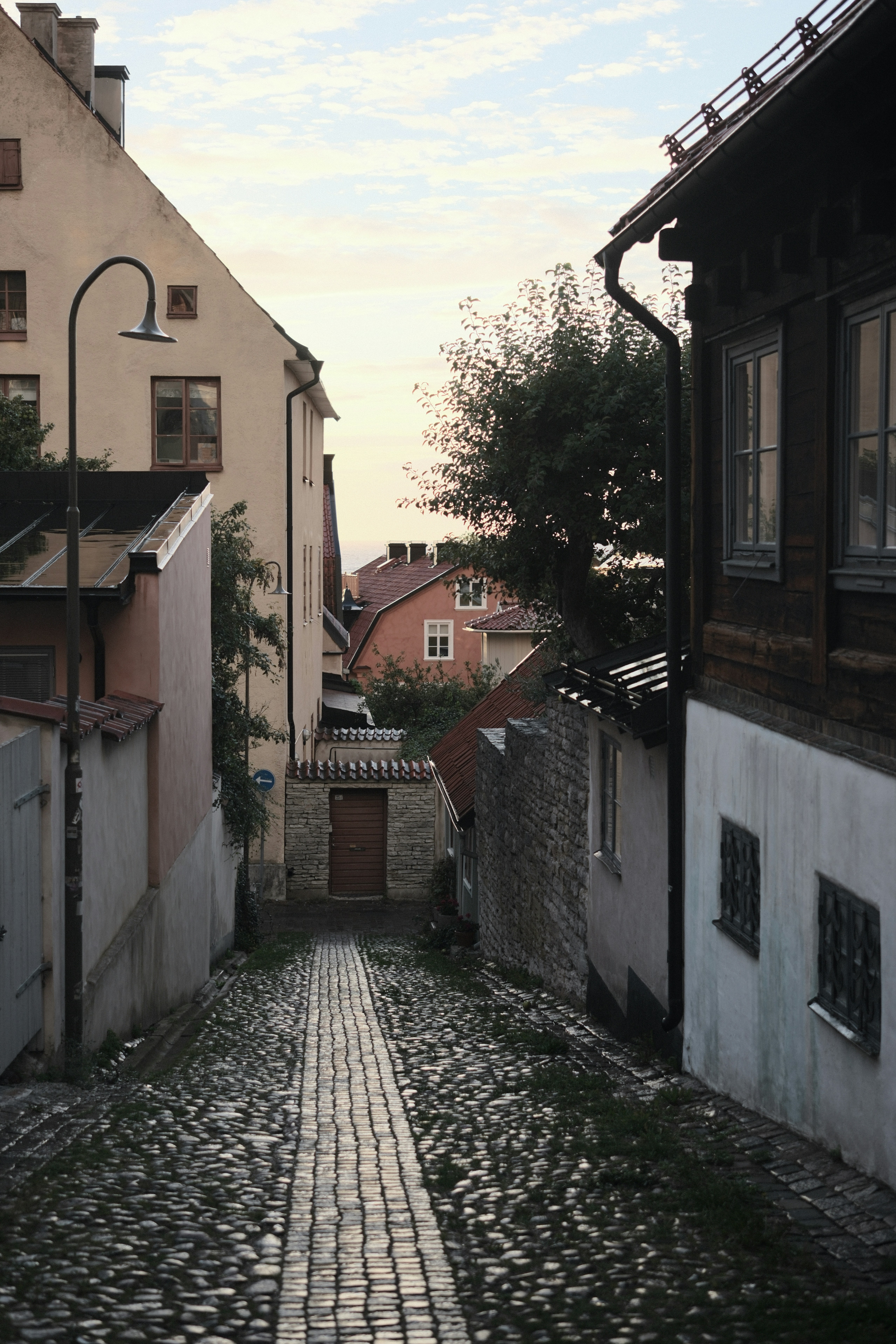 A narrow cobblestone street between old buildings in a historic town