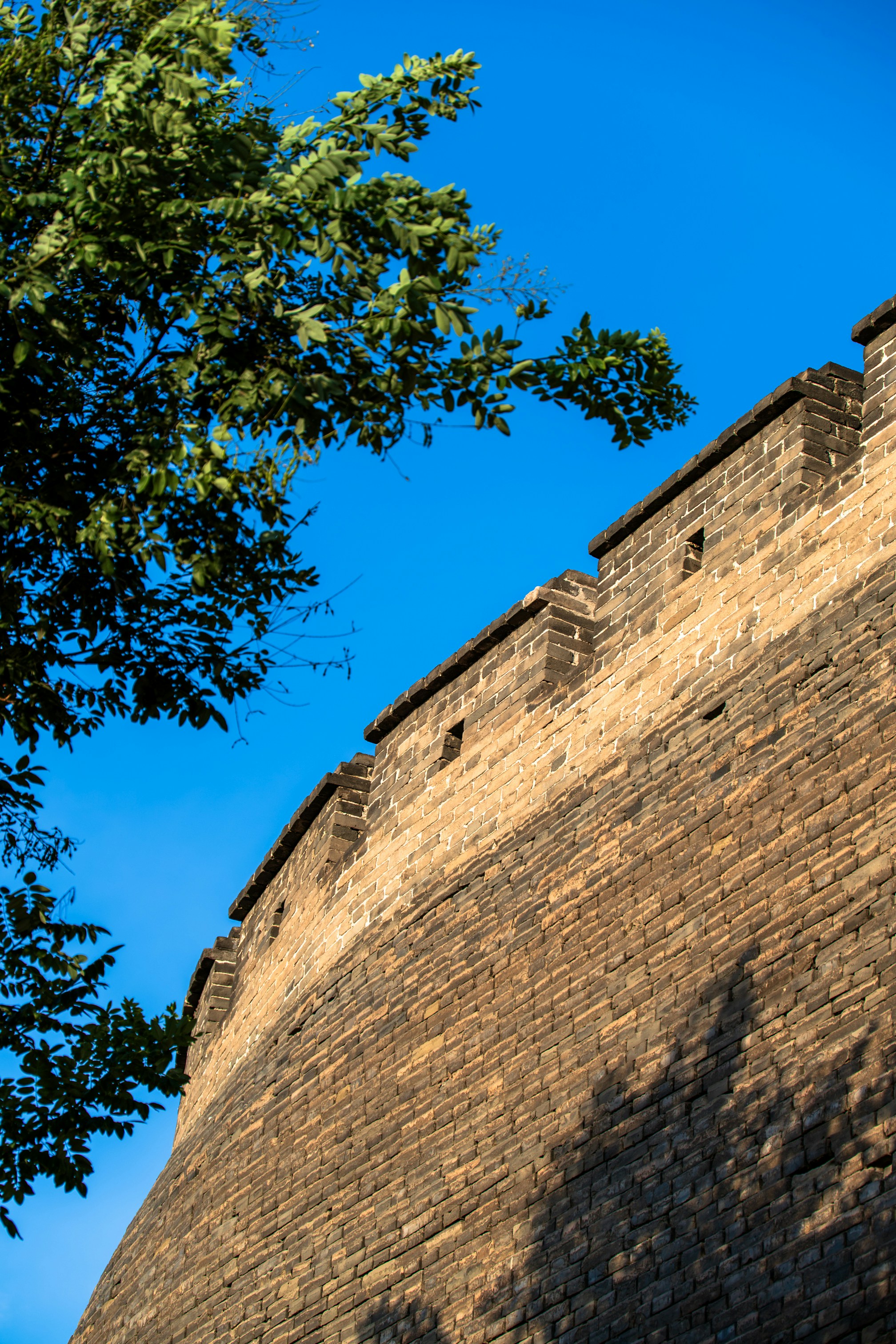 A section of the Great Wall of China against a clear blue sky