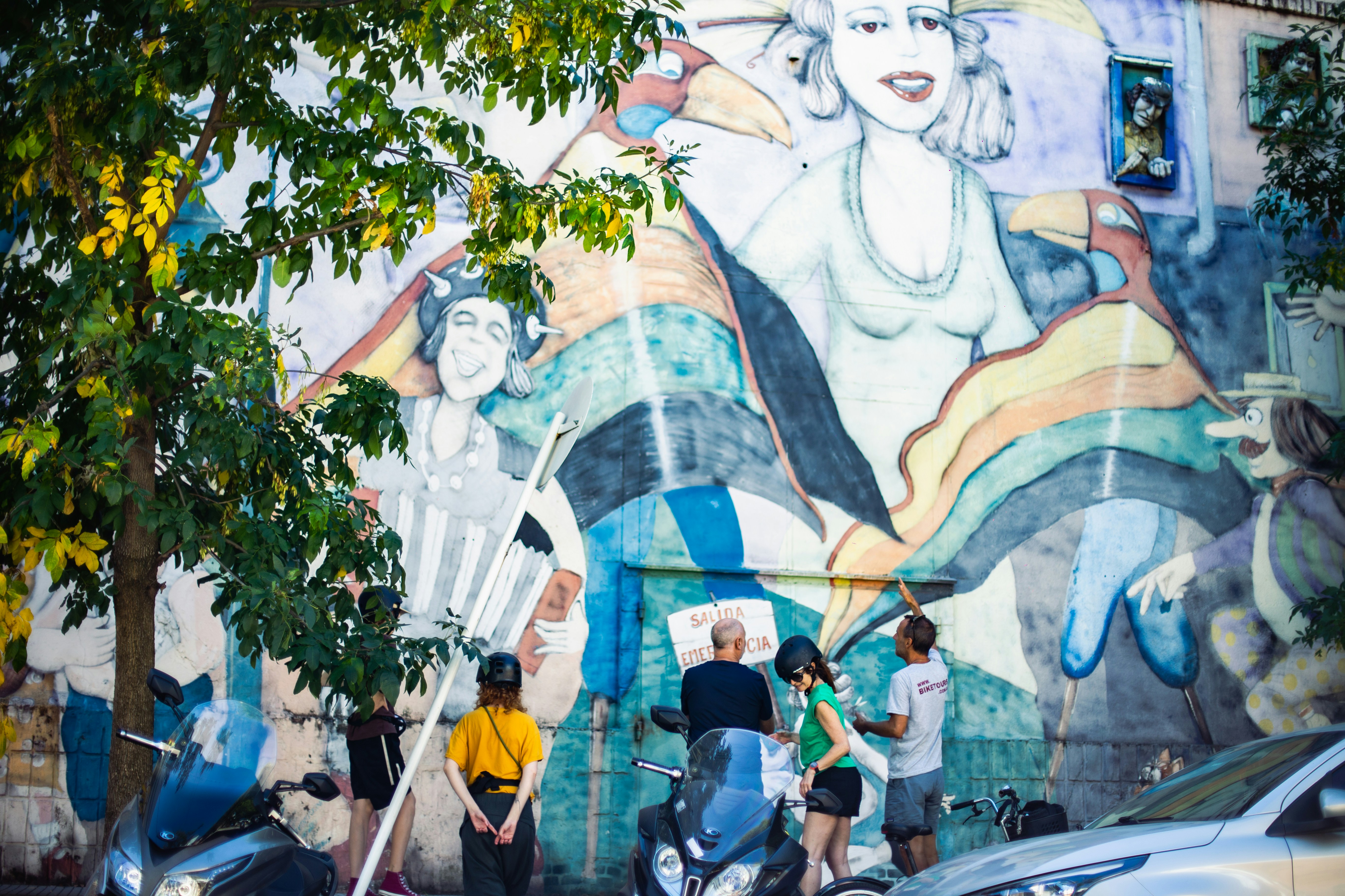 People standing before colorful city mural - Free Photo on Unsplash