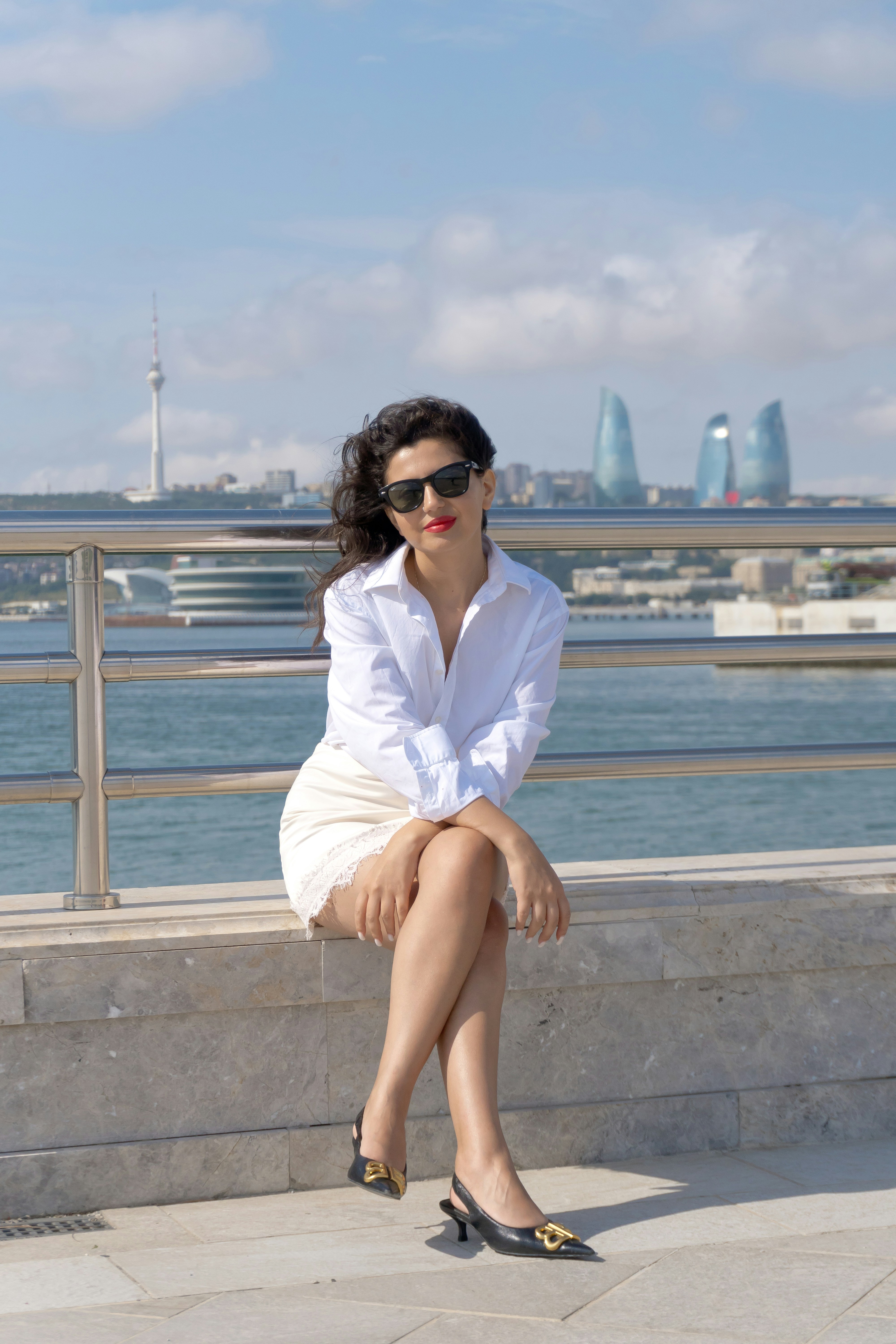 At the rail above the sea in white linen