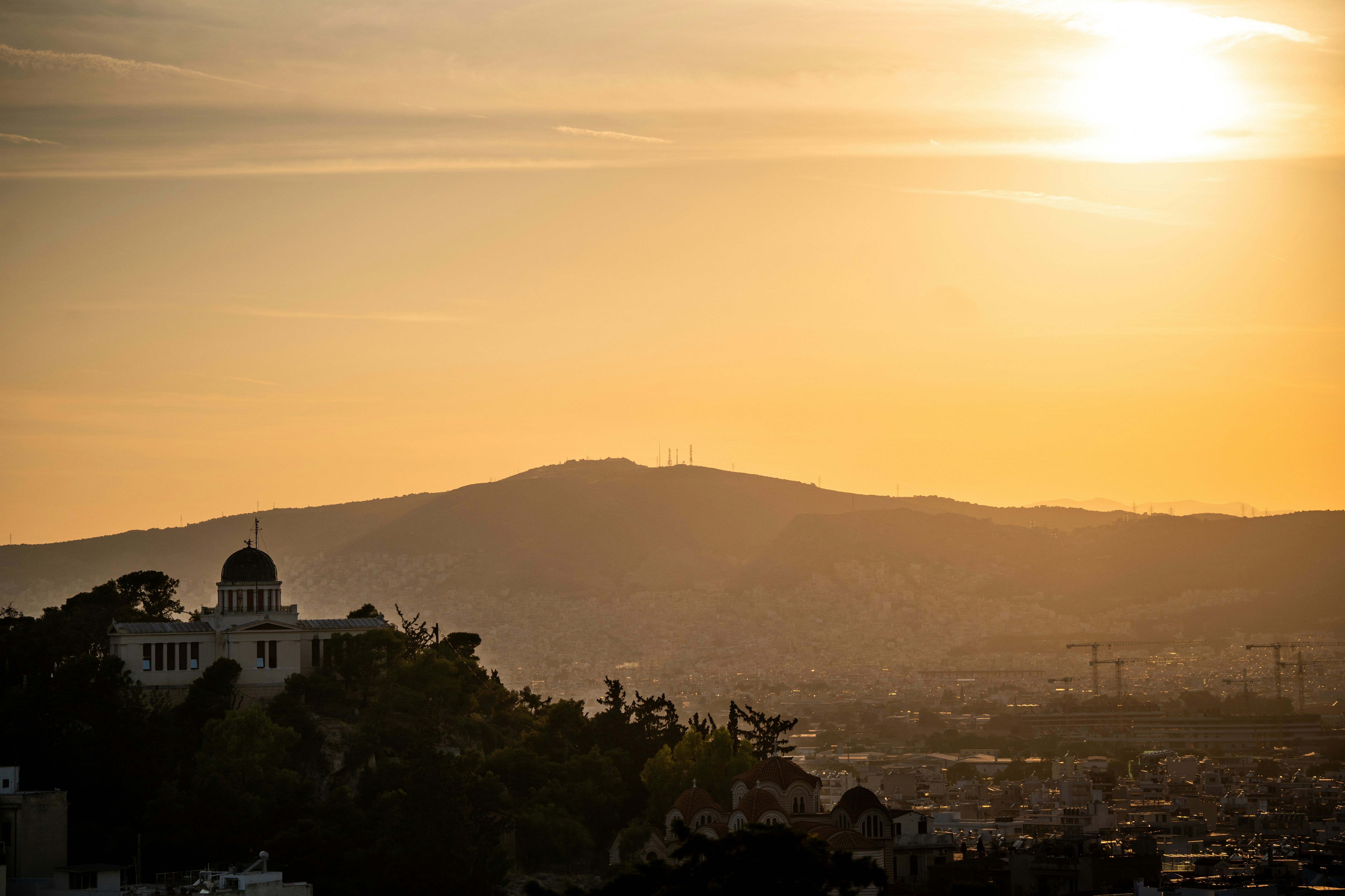 The National Observatory of Athens on a hill overlooking the city at golden hour