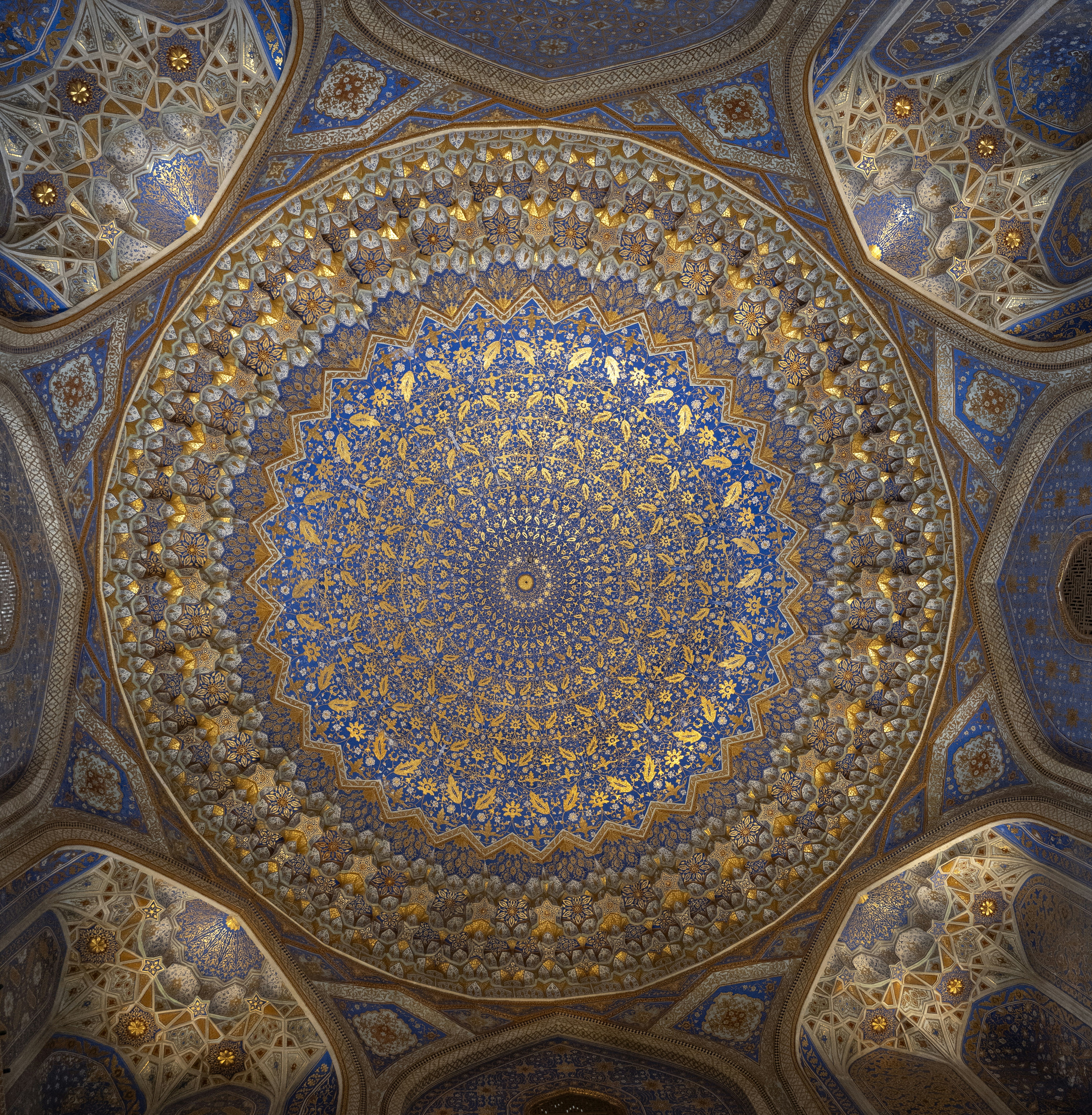 ayatollah: Intricate blue and gold geometric tile patterns on a domed ceiling