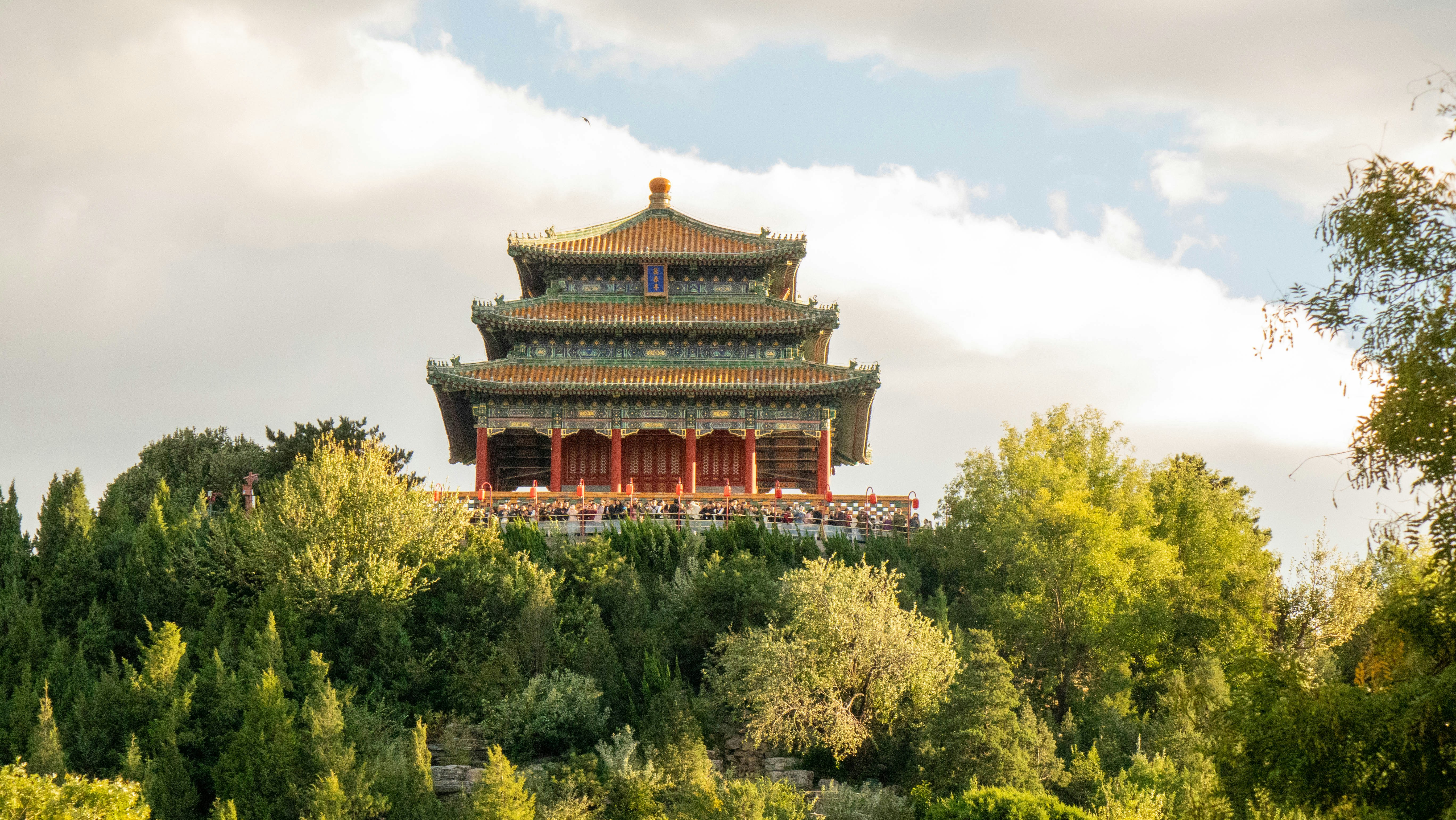 The Wanchun Pavilion atop Jingshan Hill in Beijing surrounded by lush green trees