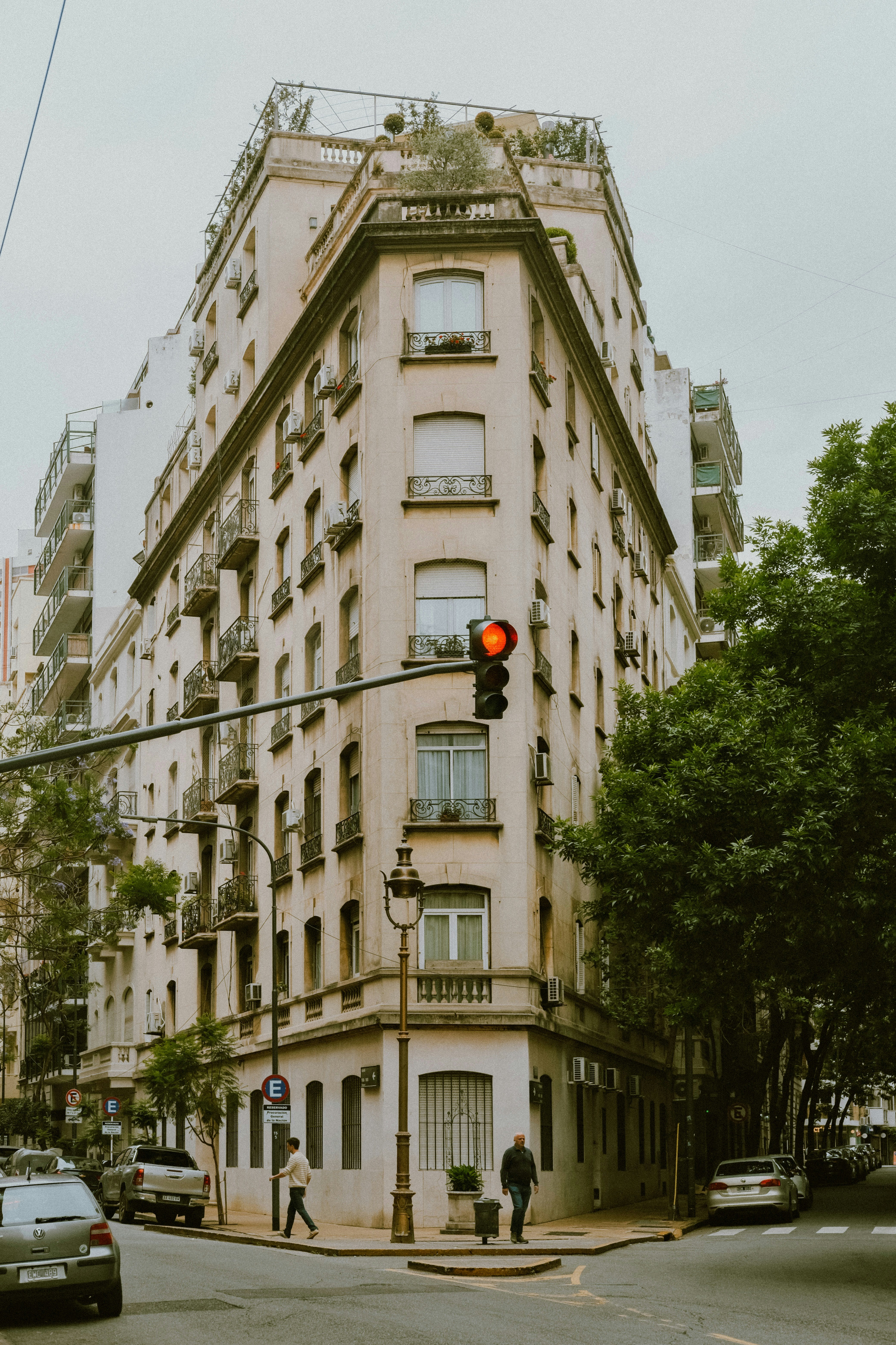 A corner apartment building with balconies on a street in Buenos Aires, Argentina