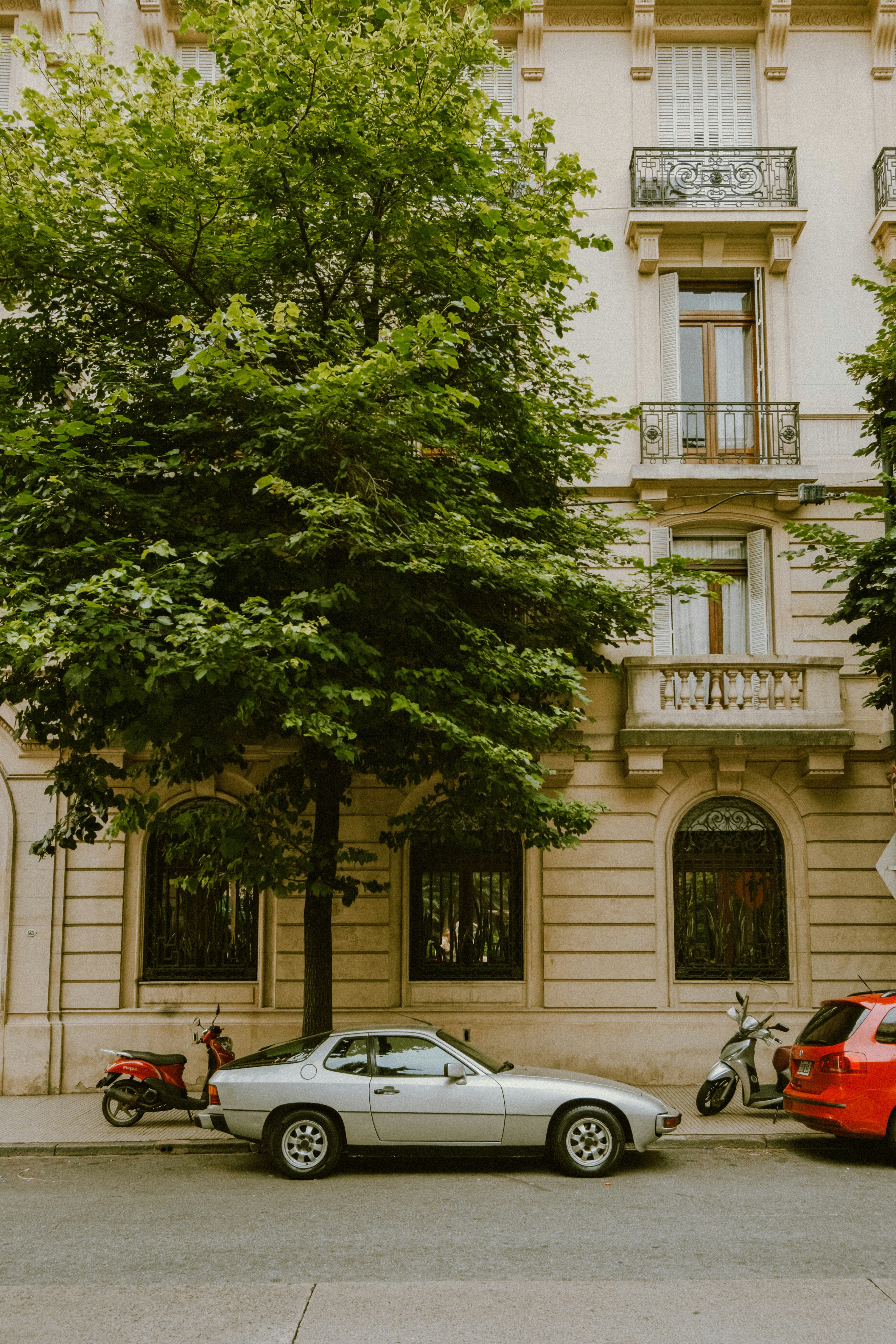 A silver car parked on a street in front of a building in Buenos Aires