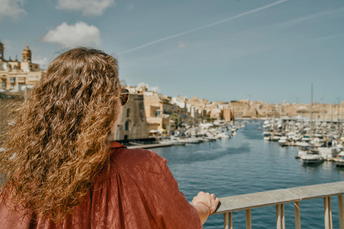 A traveller looking out over the harbour in Valletta