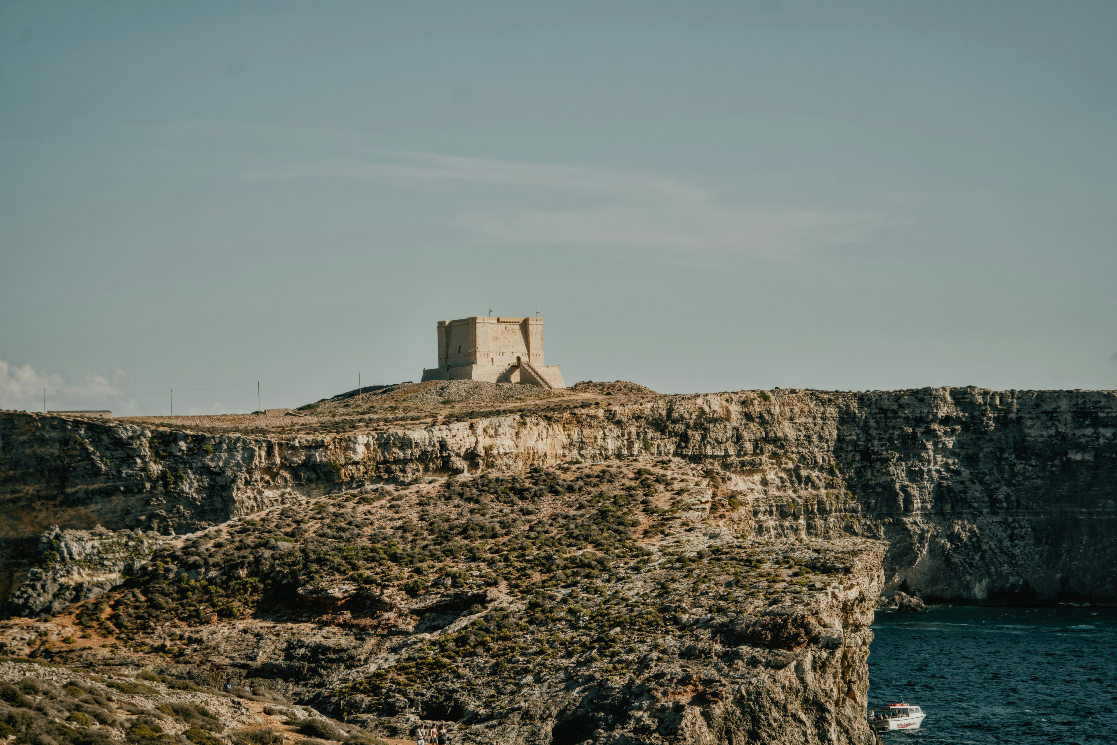 A stone watchtower on a rocky cliff overlooking the sea