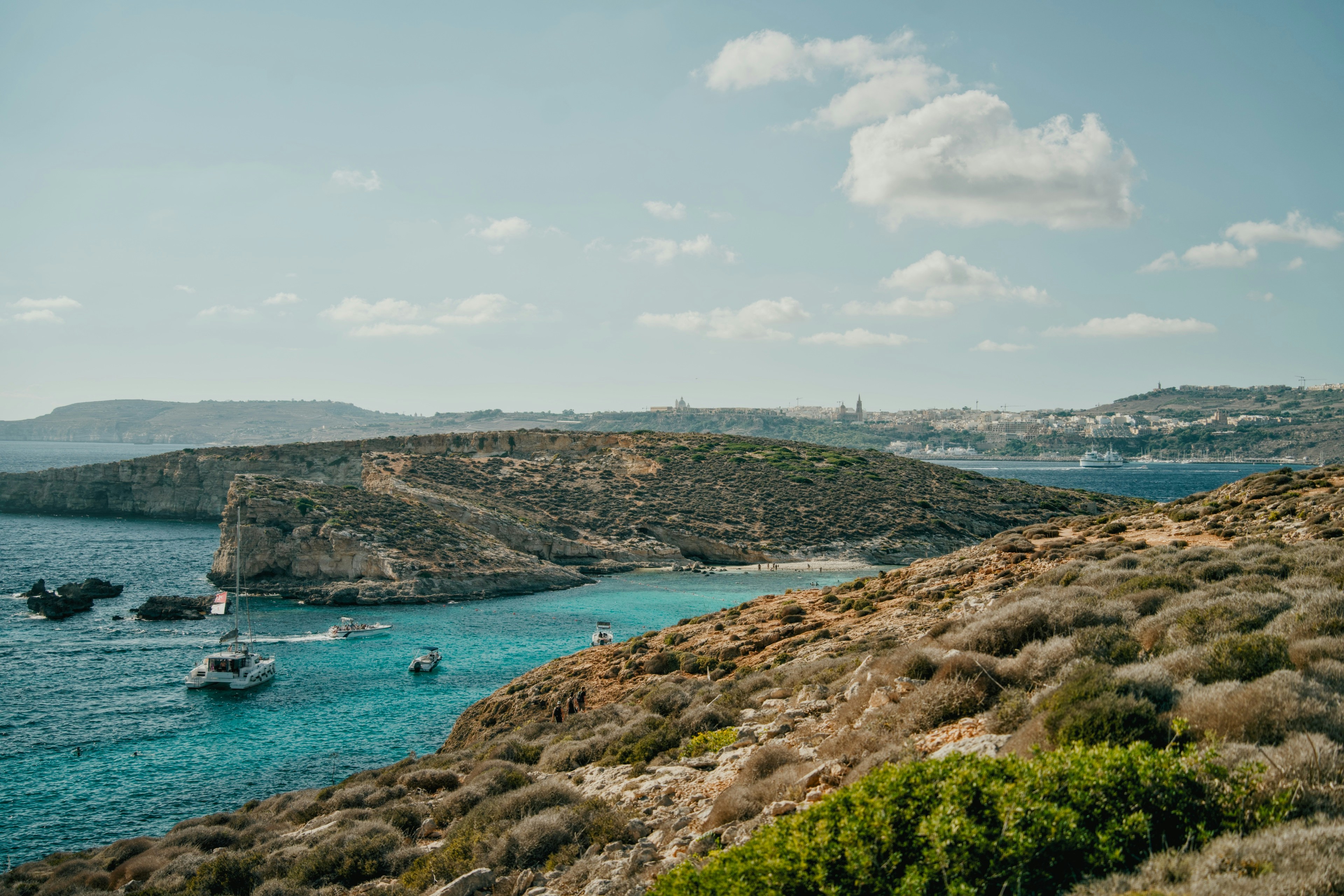 Boats in the turquoise waters of the Blue Lagoon on Comino island in Malta