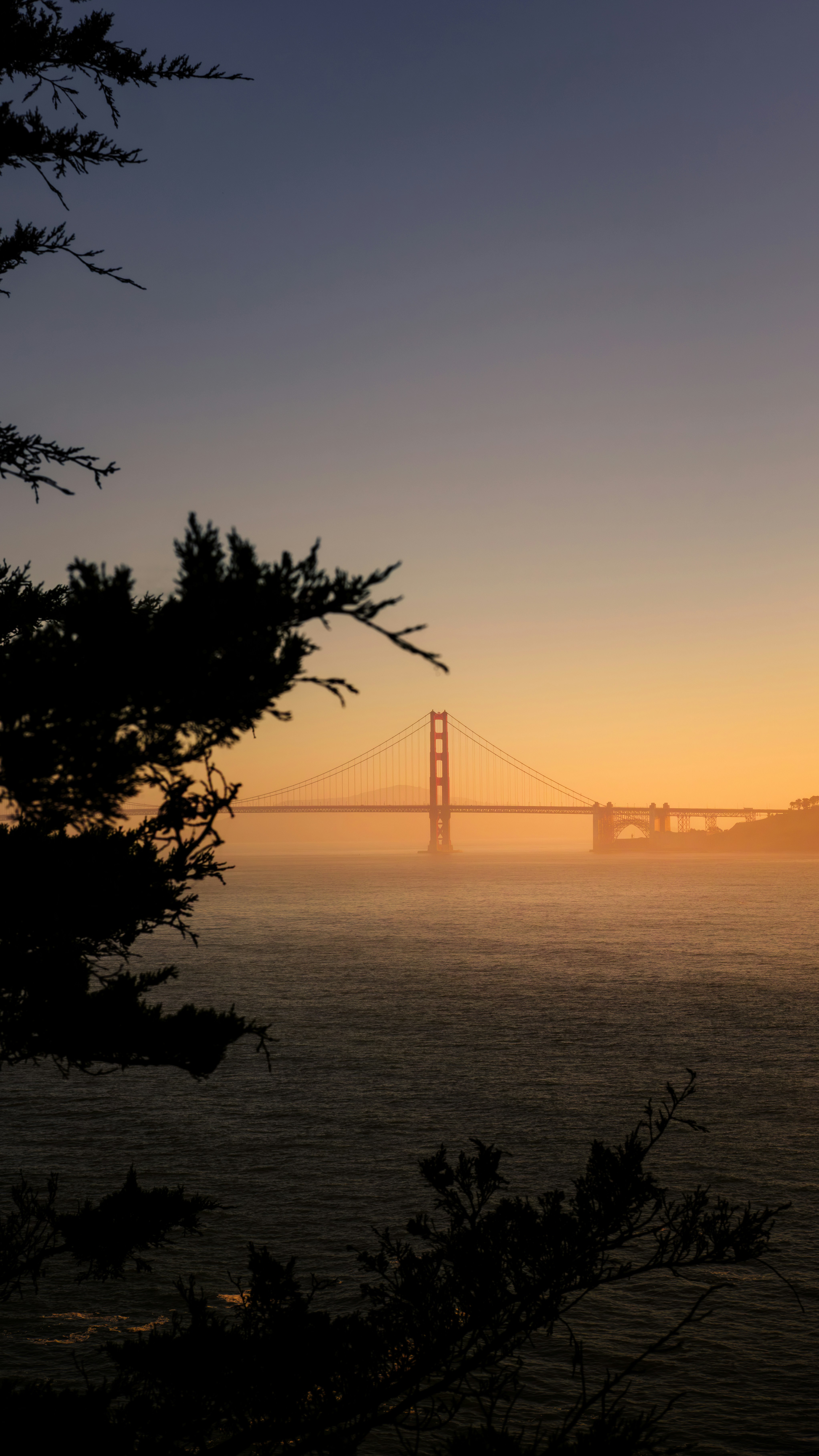 The Golden Gate Bridge in San Francisco at low sun over the water